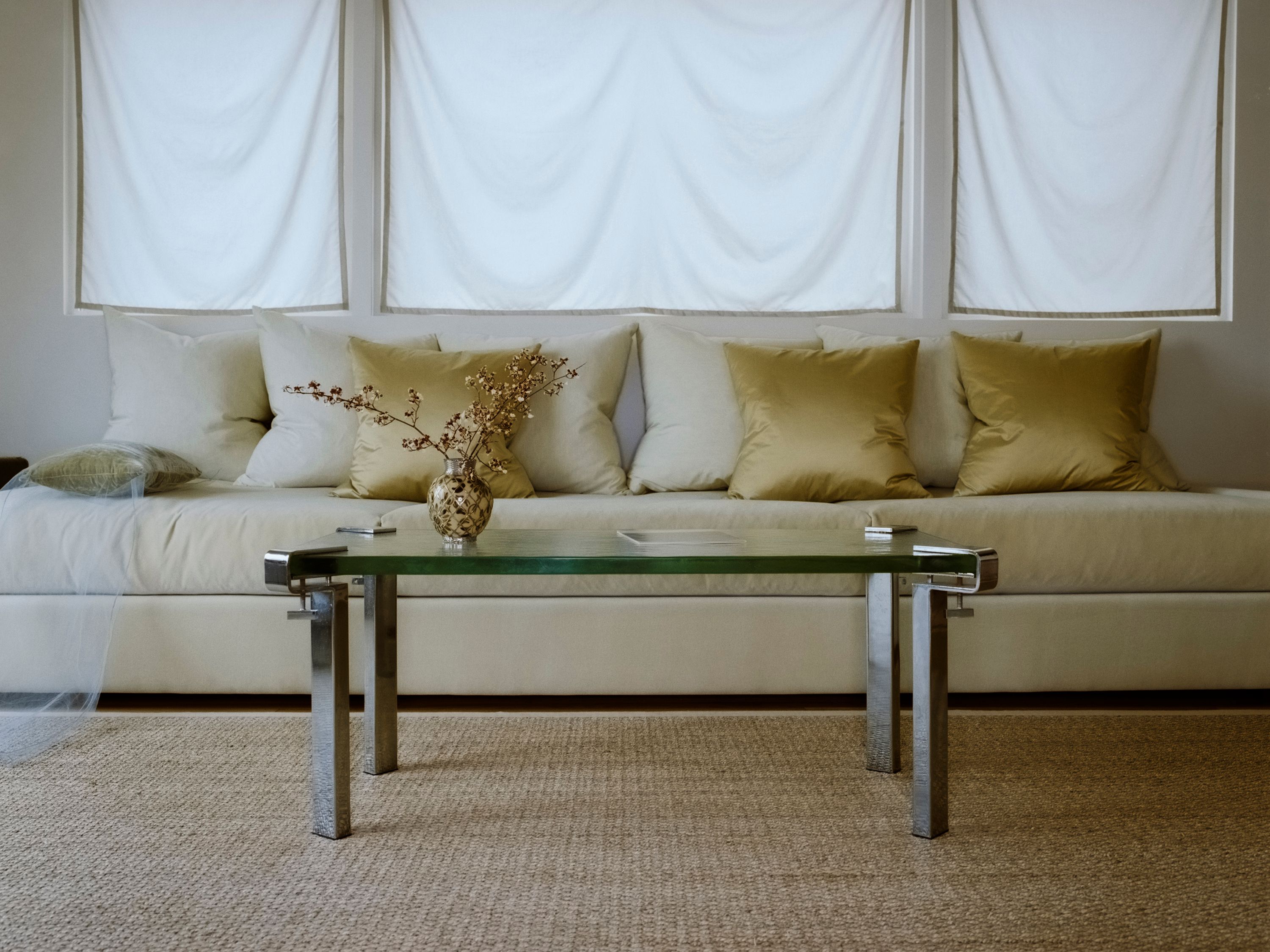 a yellow-green velvet sofa with tonal silk pillows, WOE, Width Over Ears, IKO IKO