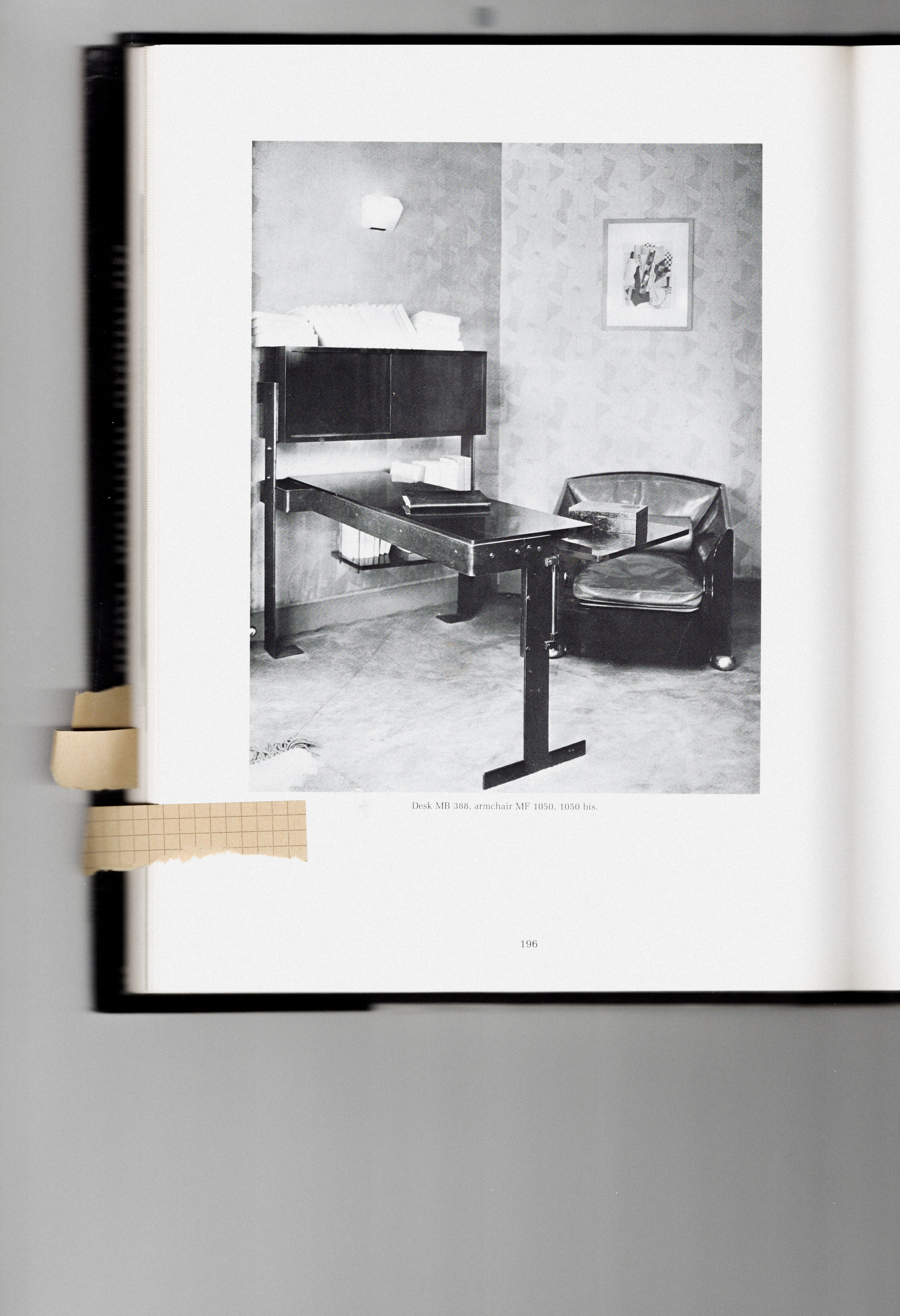 a black and white scan of a room with a metal desk and lounge chair, WOE, Width Over Ears