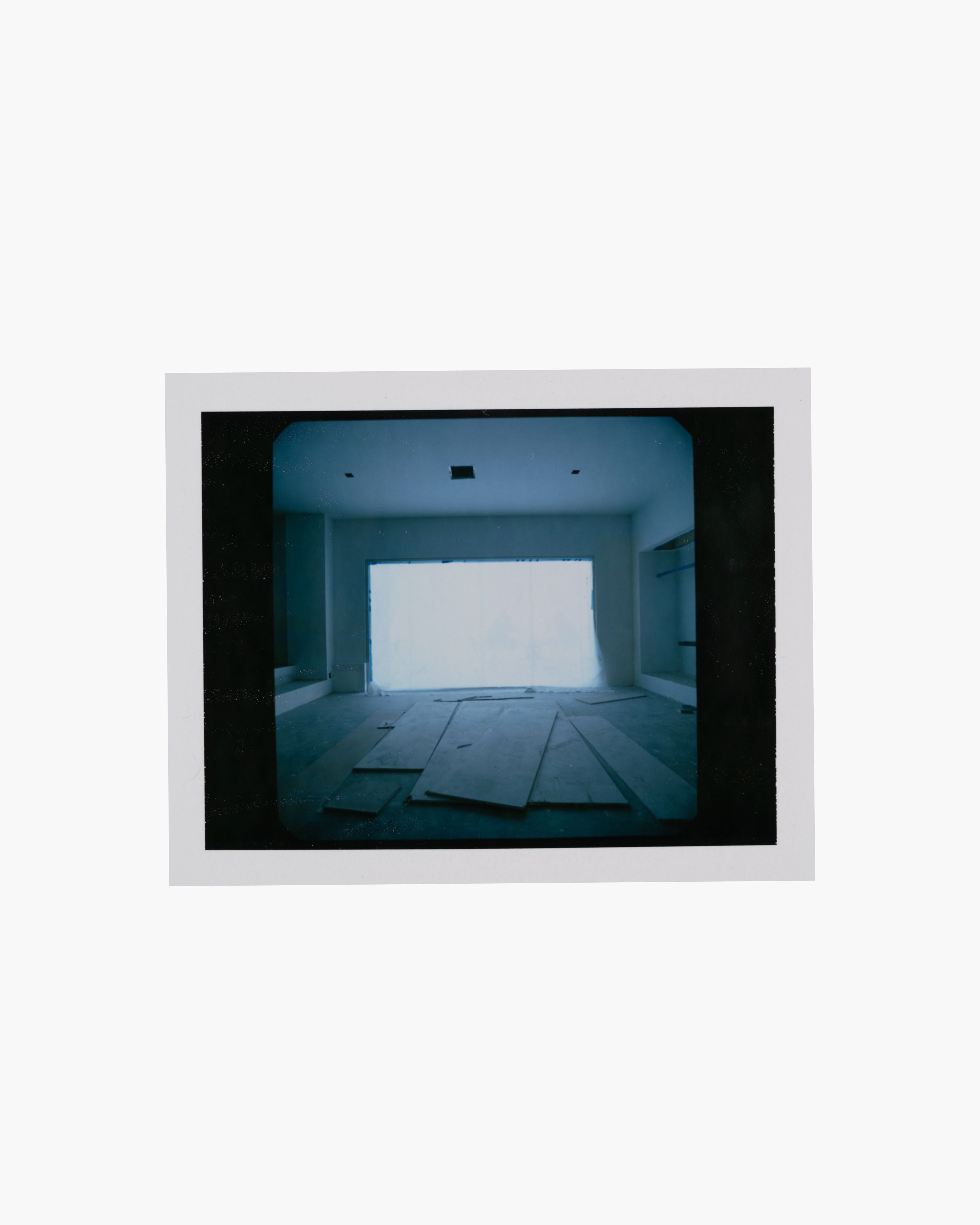 a polaroid image of an empty room under construction, WOE, Width Over Ears