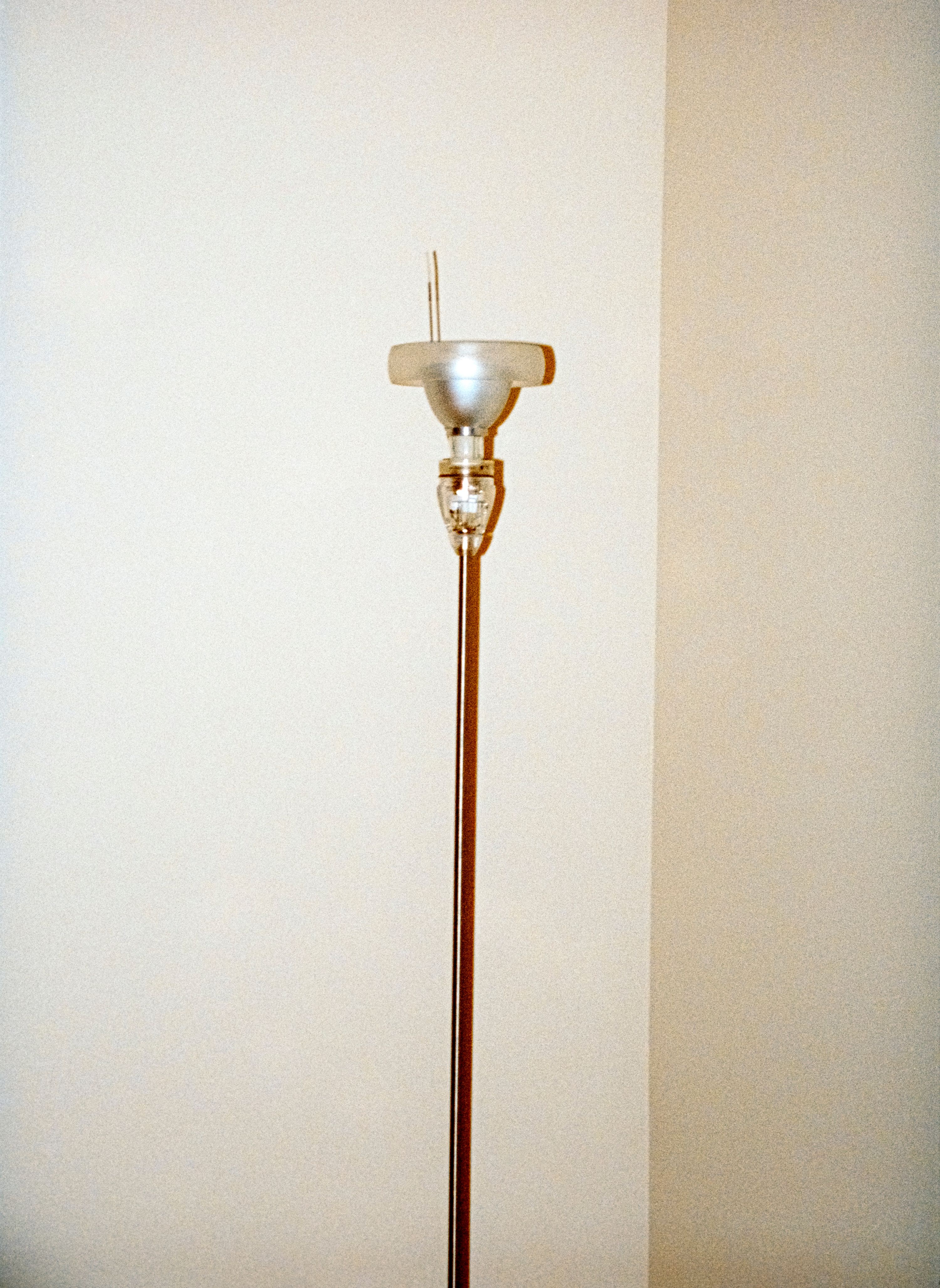 a floor lamp against a white wall