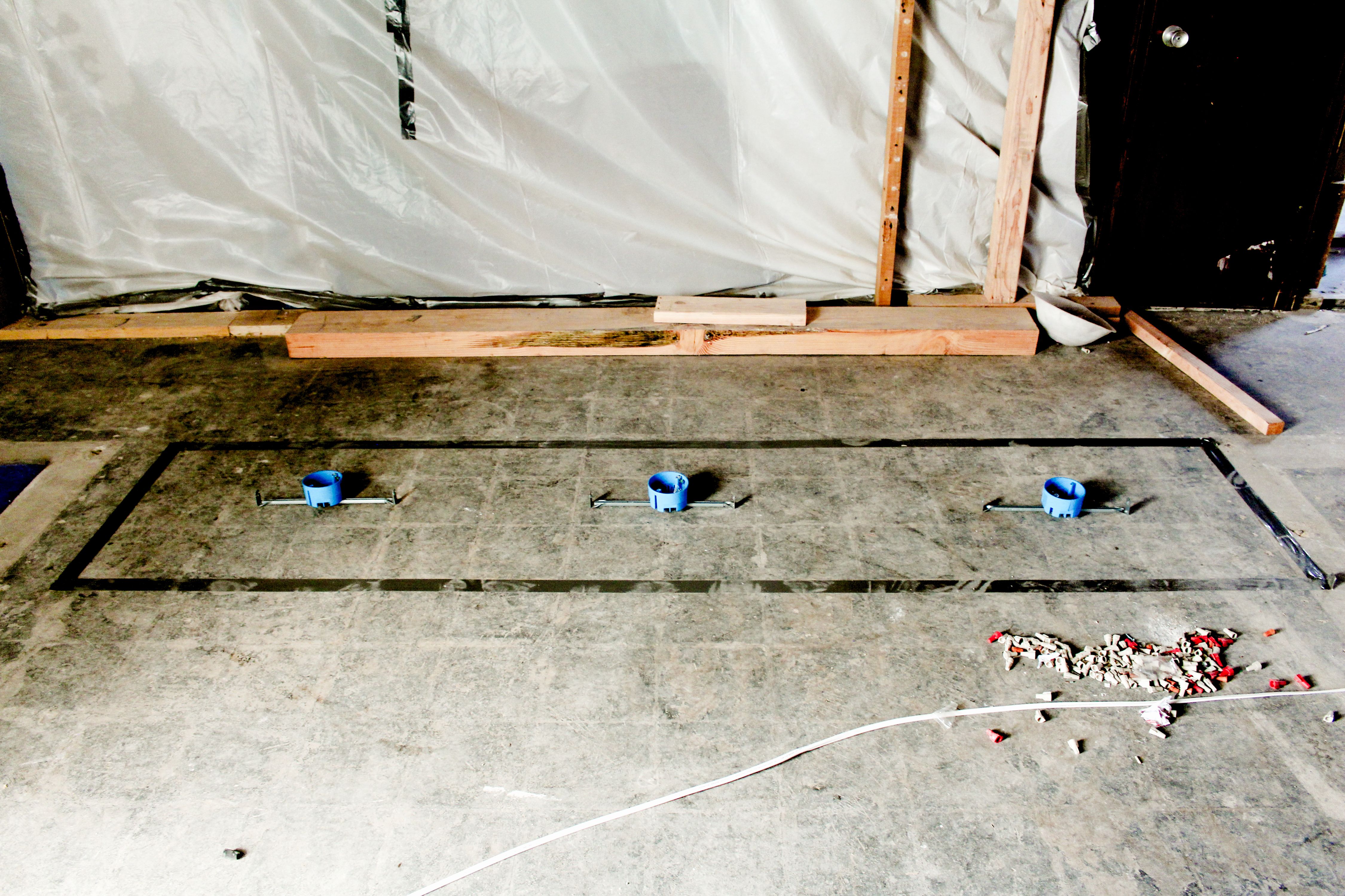 three blue electrical boxes on a concrete ground, WOE, Width Over Ears