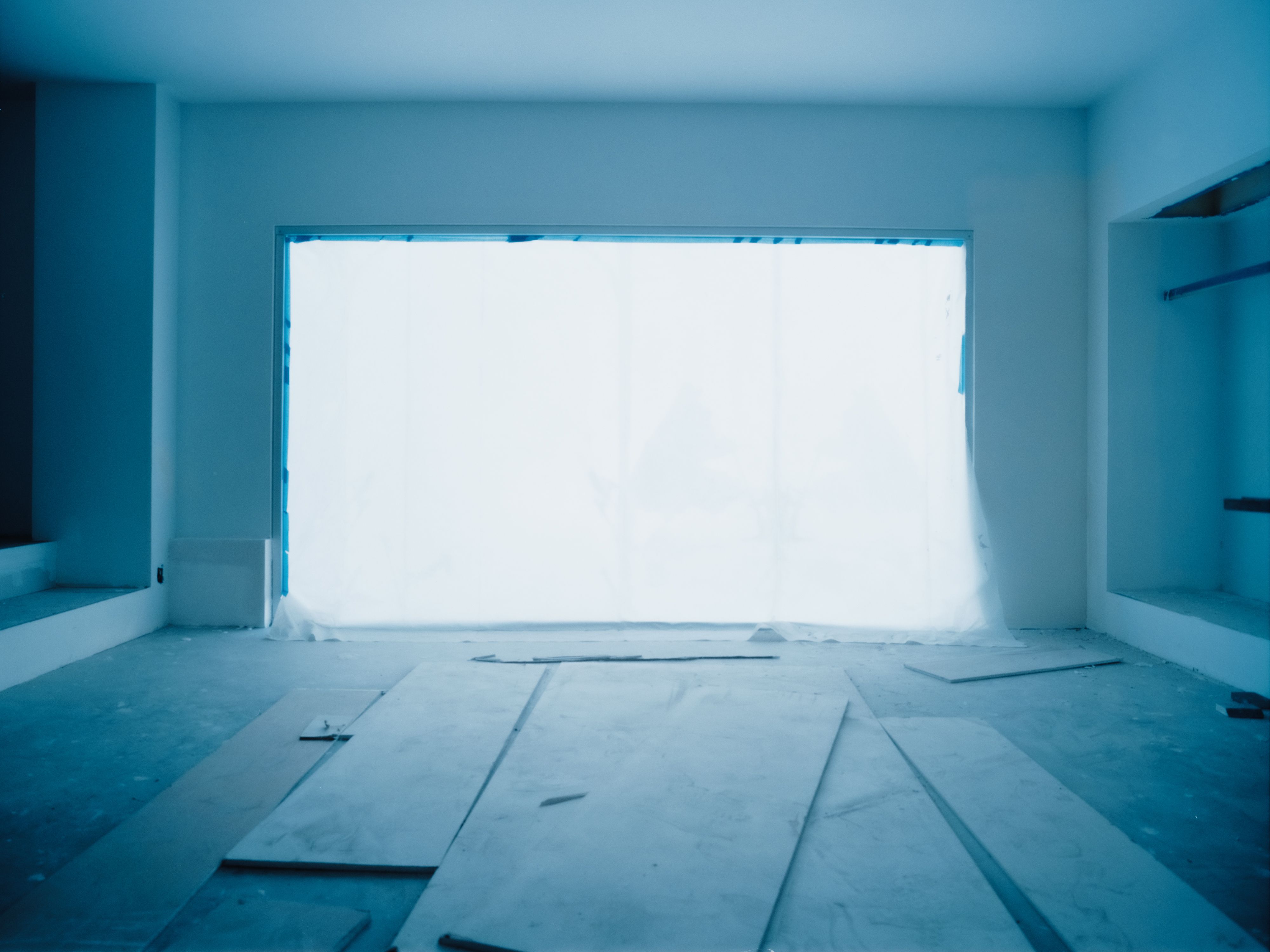 a large window within a large room with a blue hue, WOE, Width Over Ears