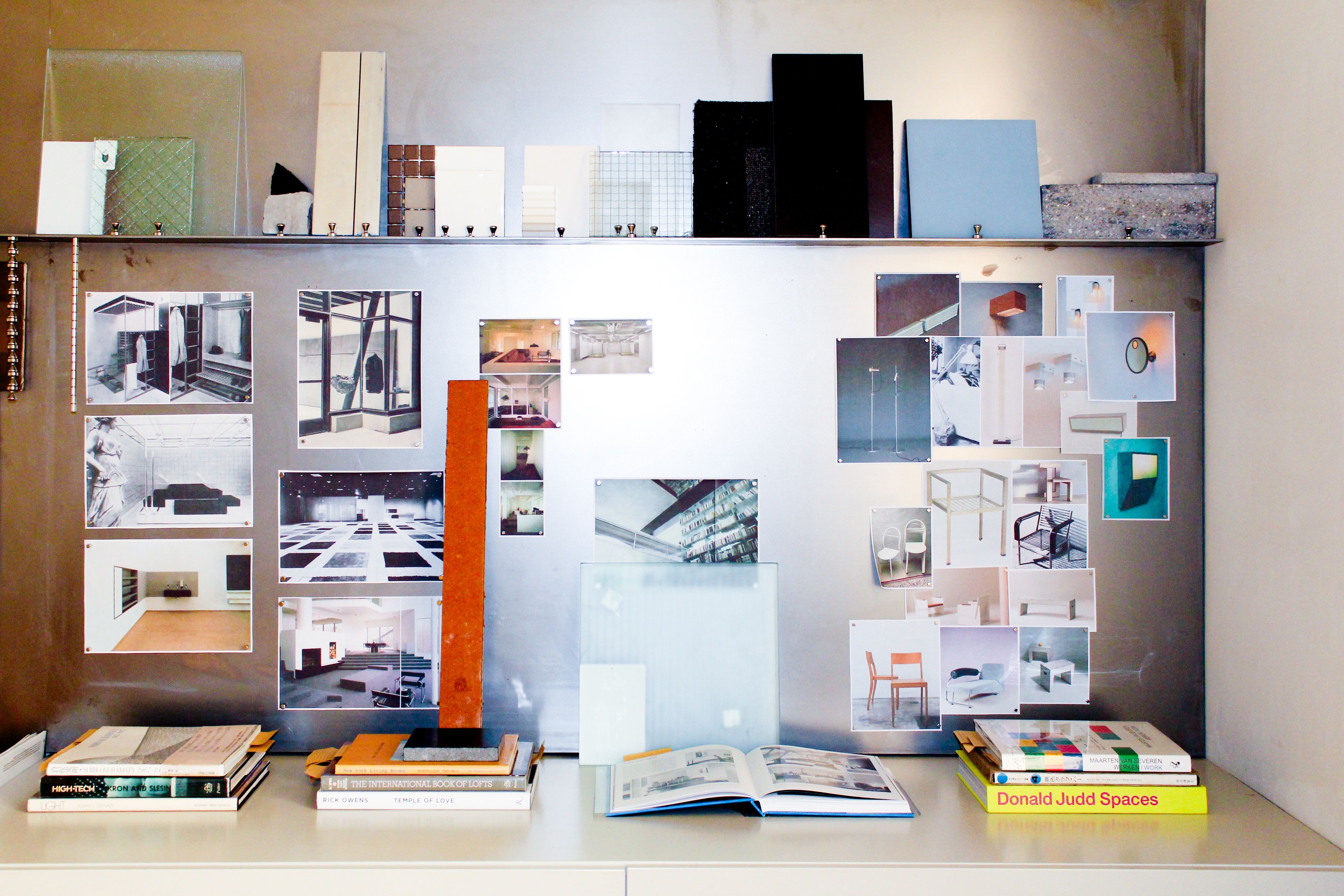 a metal wall with various reference images and materials pinned to it, WOE, Width Over Ears