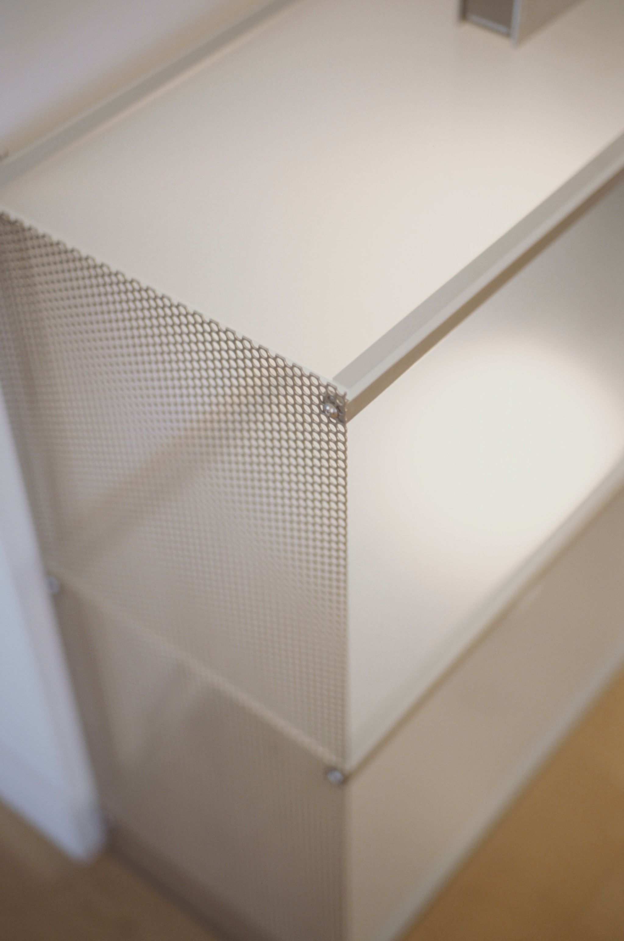 metal and glass shelving on wooden flooring