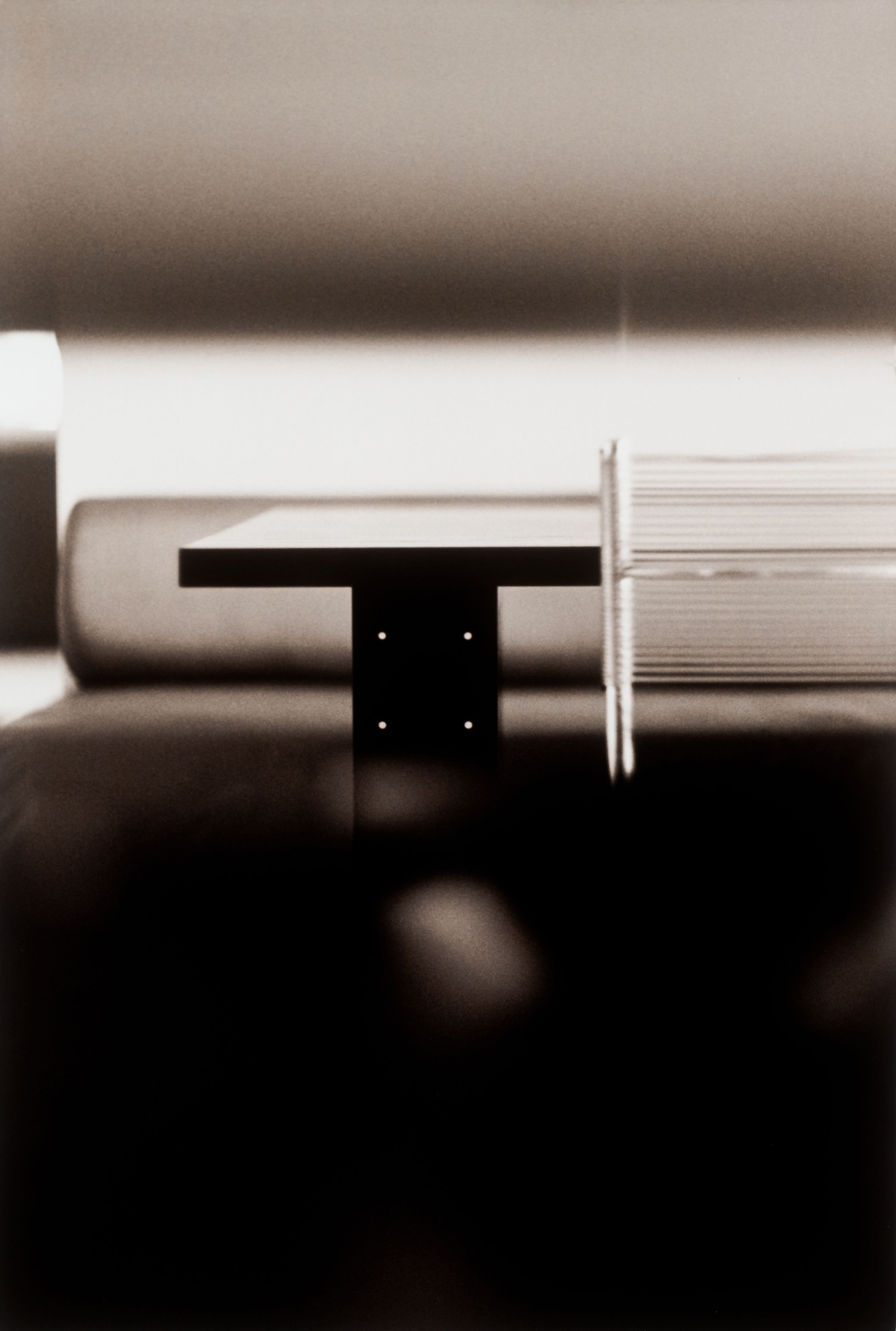 a black and white abstract image  of a chair and table