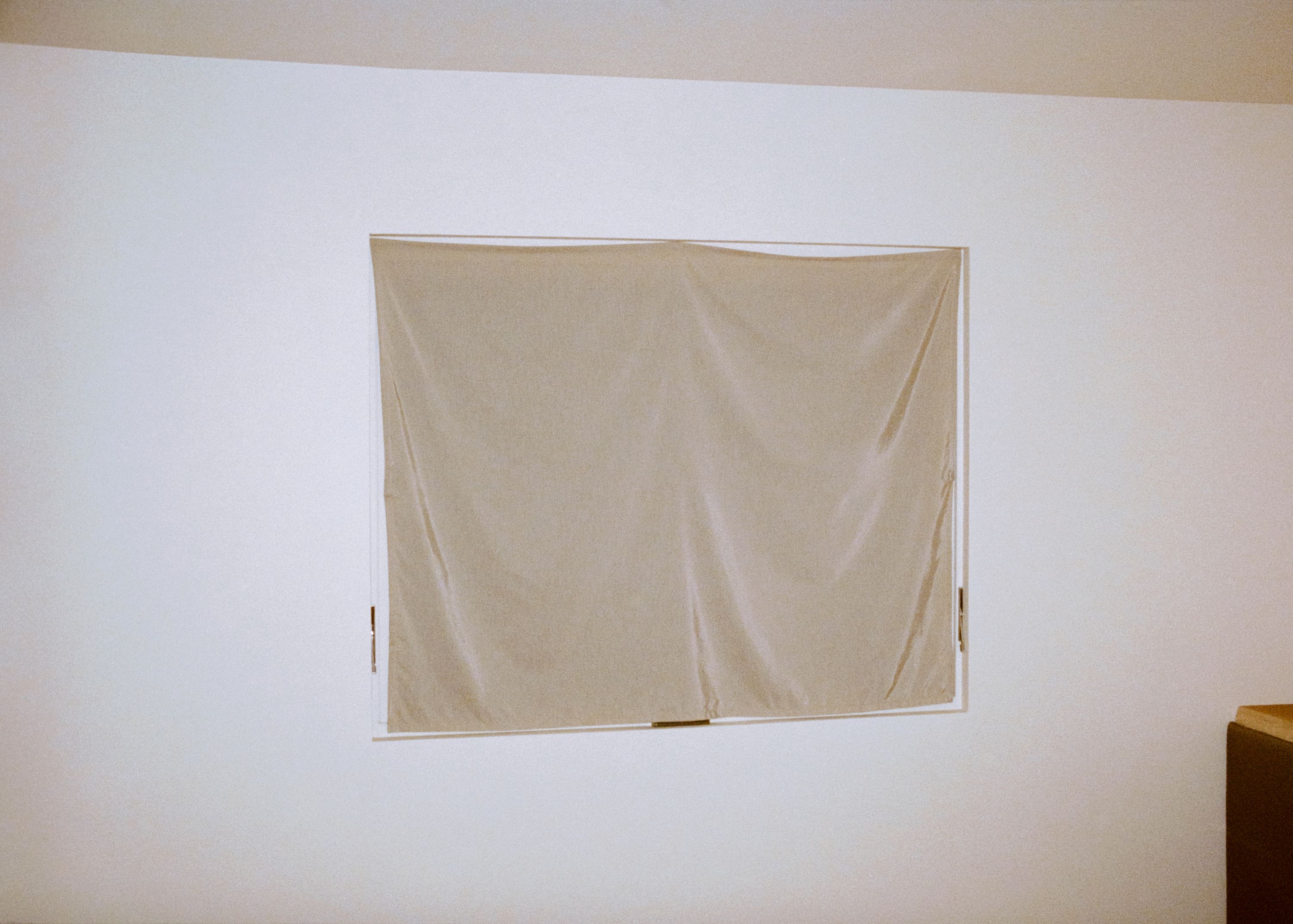 a beige curtain over a window