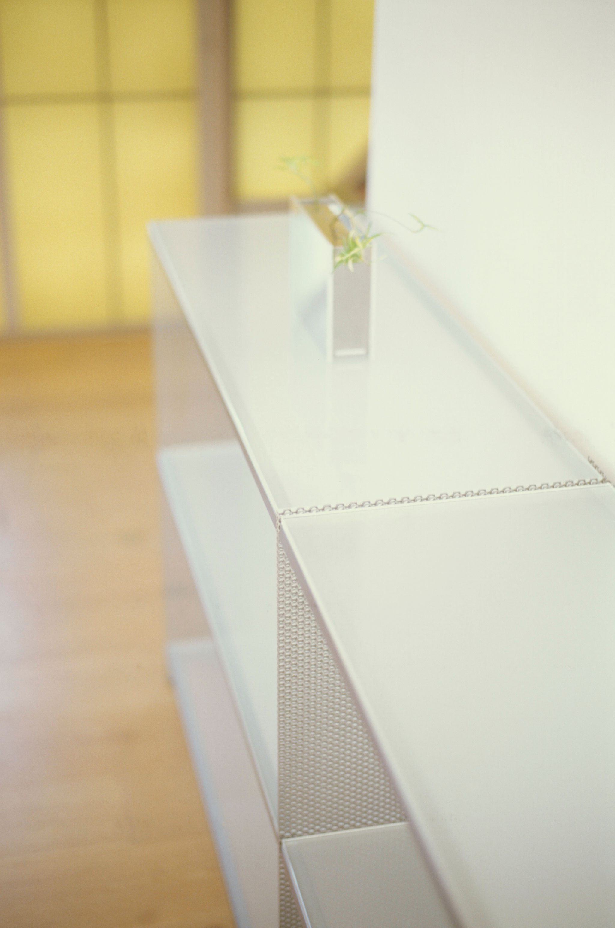 metal and glass shelving on wooden flooring