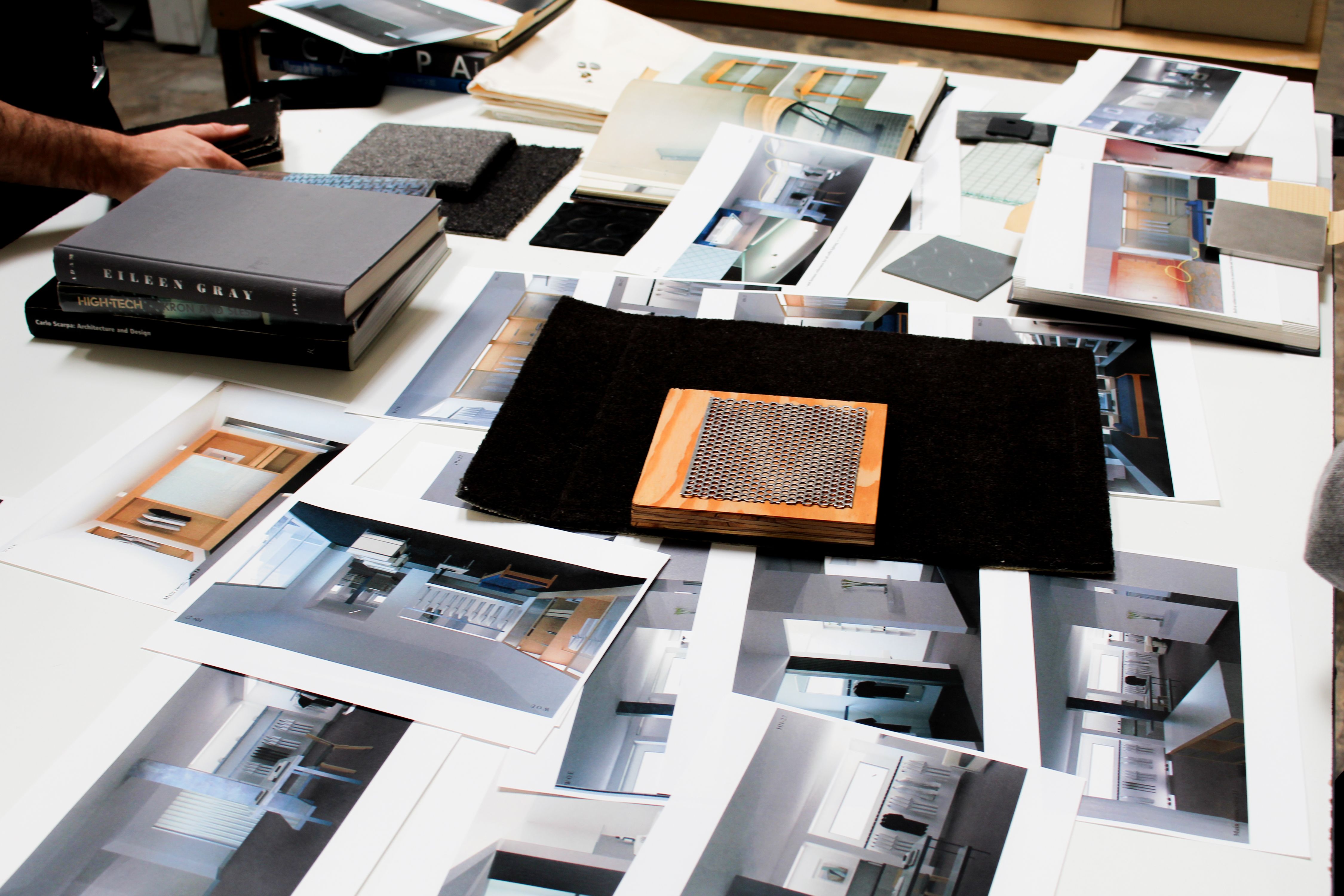 a table with images and materials strewn across it, WOE, Width Over Ears