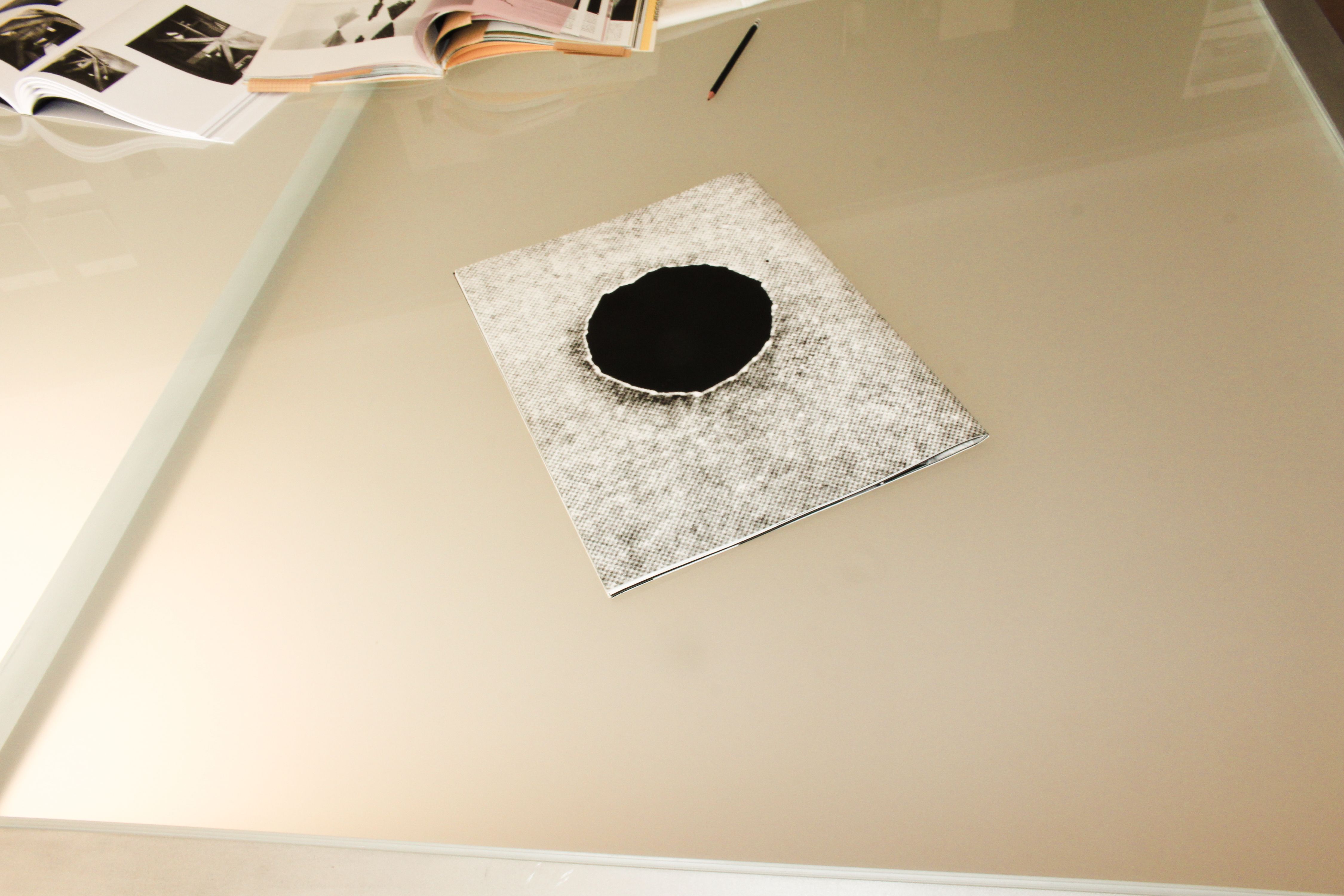 an etched glass table with a black and white photograph on the tabletop