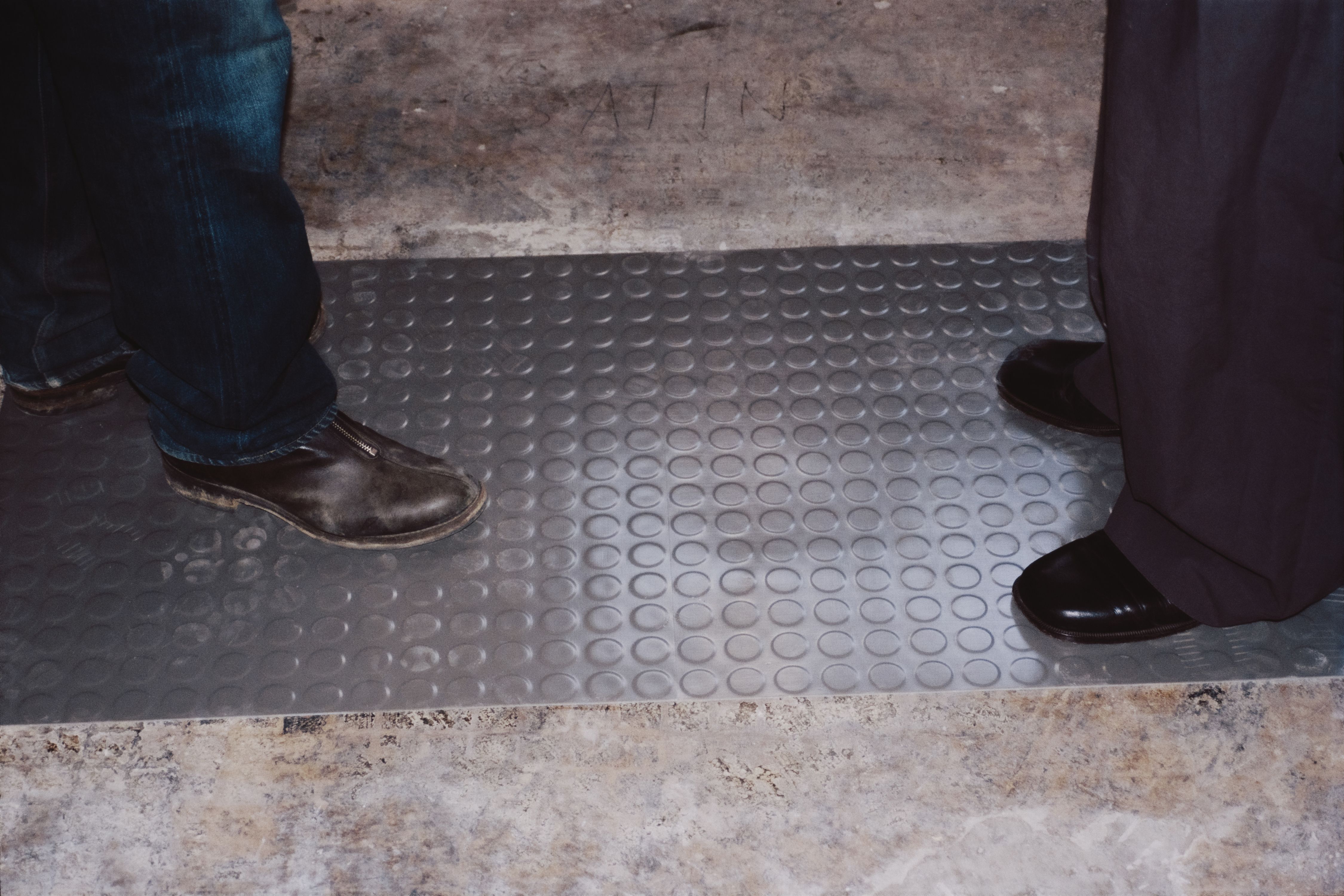 two pairs of shoes standing on a grey rubber coin tile floor, WOE, Width Over Ears