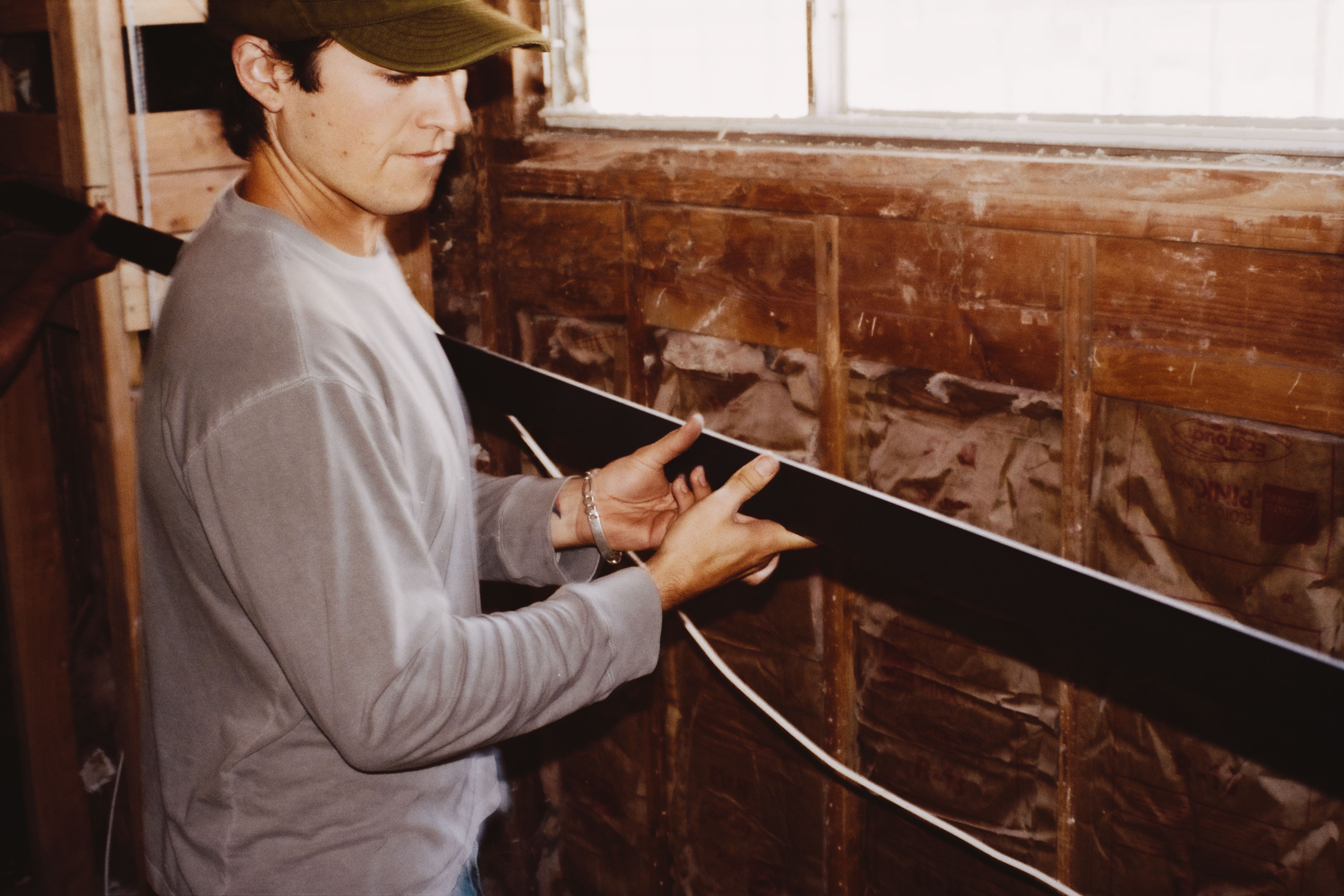an image of a man holding a steel rail, WOE, Width Over Ears