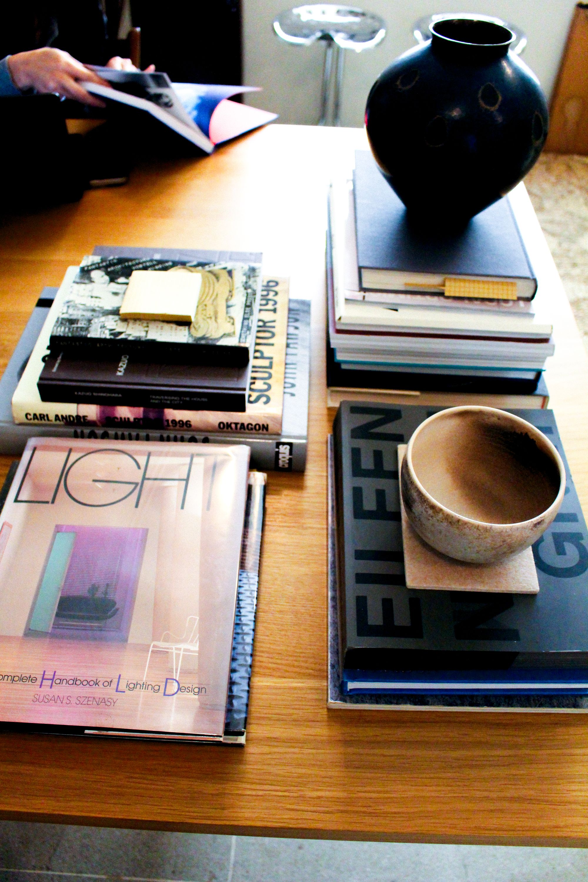 a group of books and vases on a table