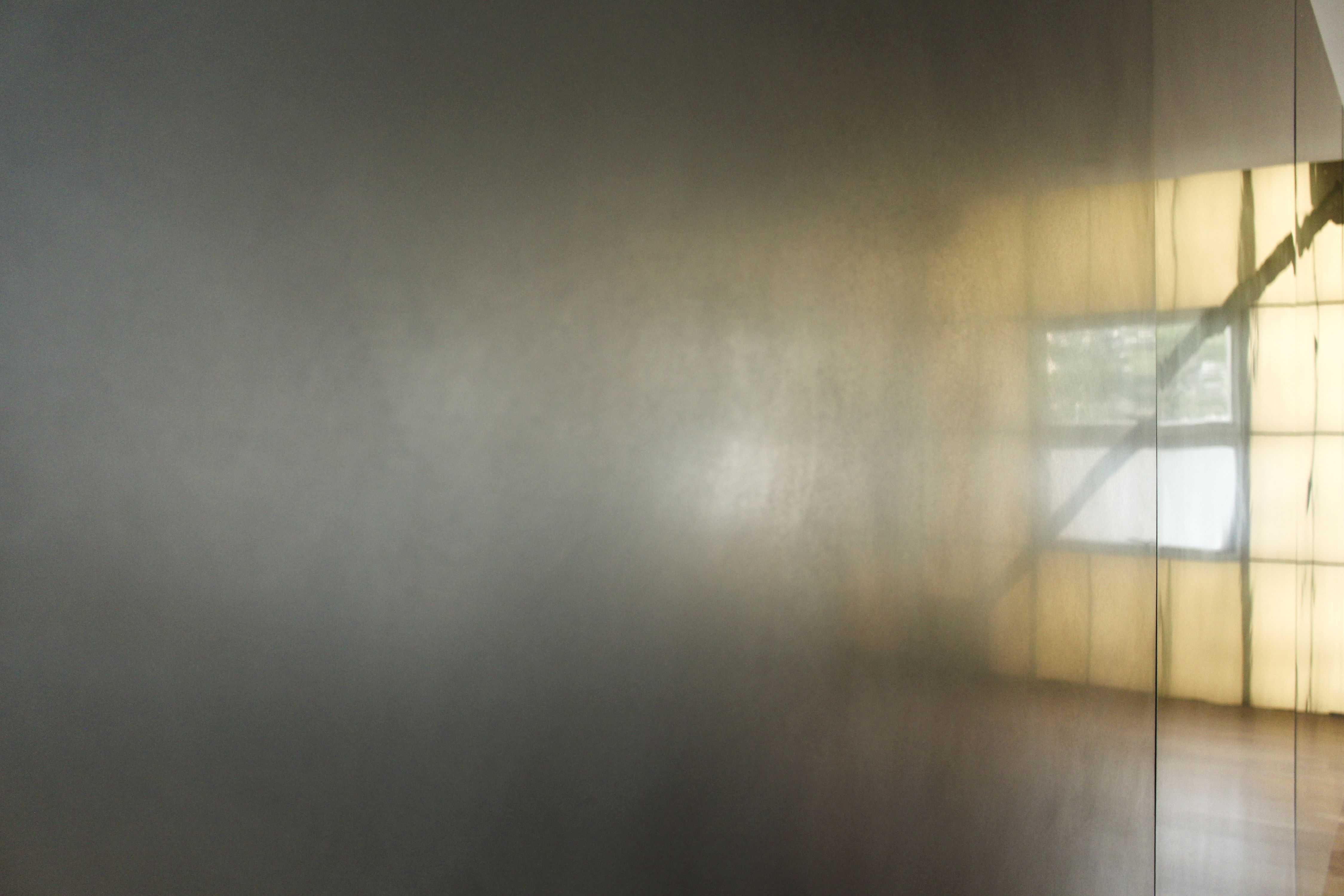 a stainless steel wall with reflections on it