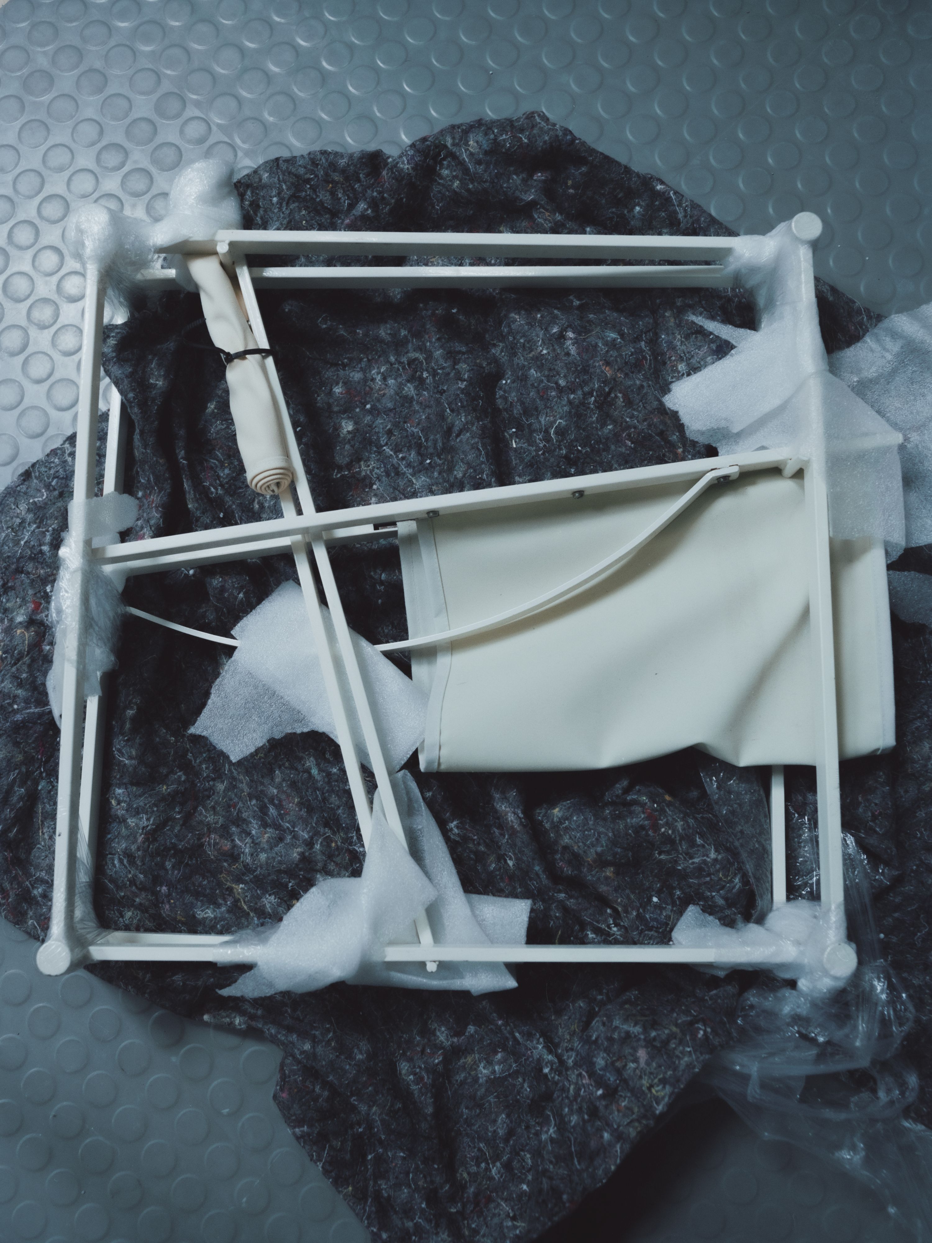 a deconstructed chair on a moving blanket, WOE, Width Over Ears