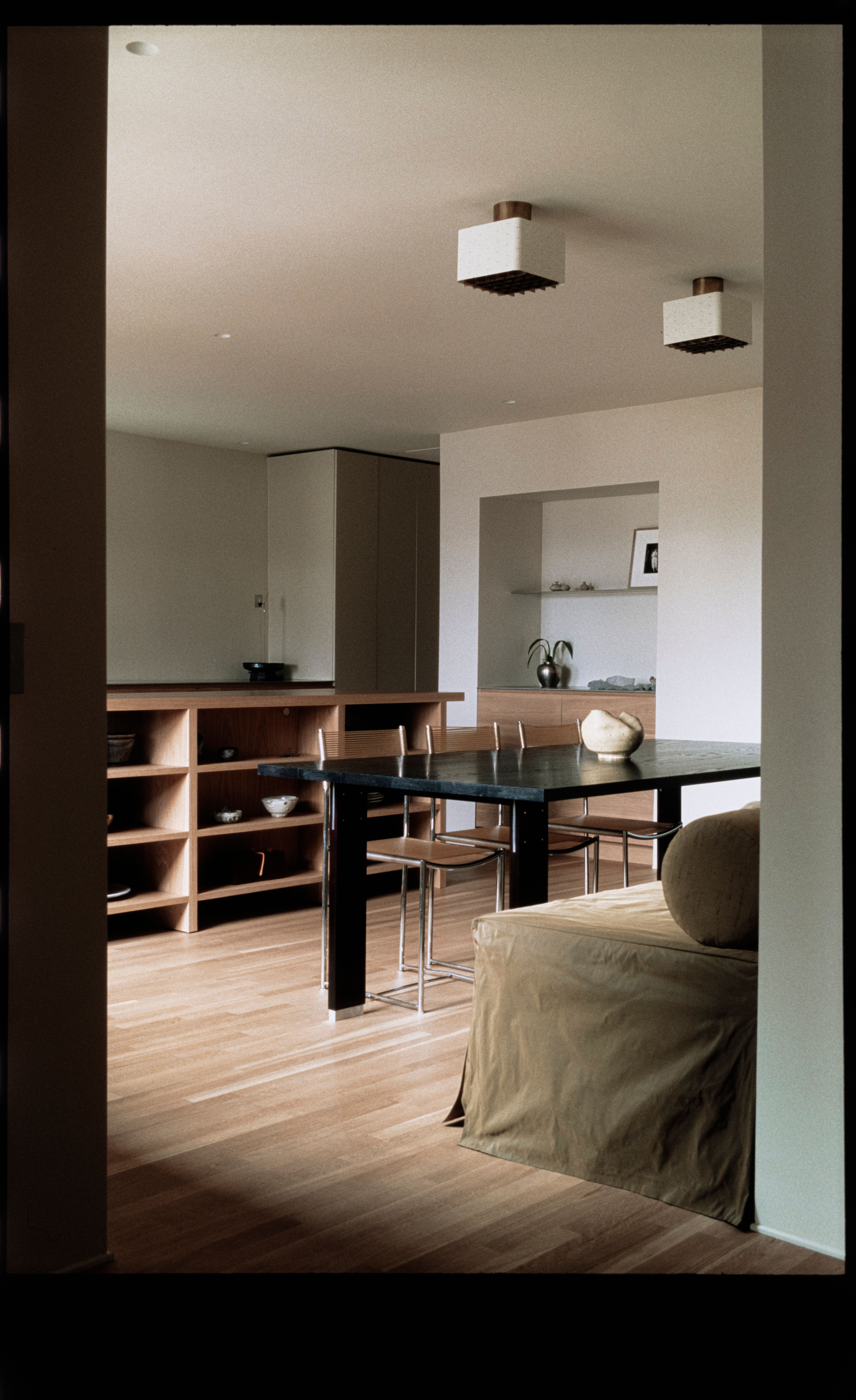 dining room with green fabric bench, light wood floors, and white ceiling fixtures, woe, width over ears, design