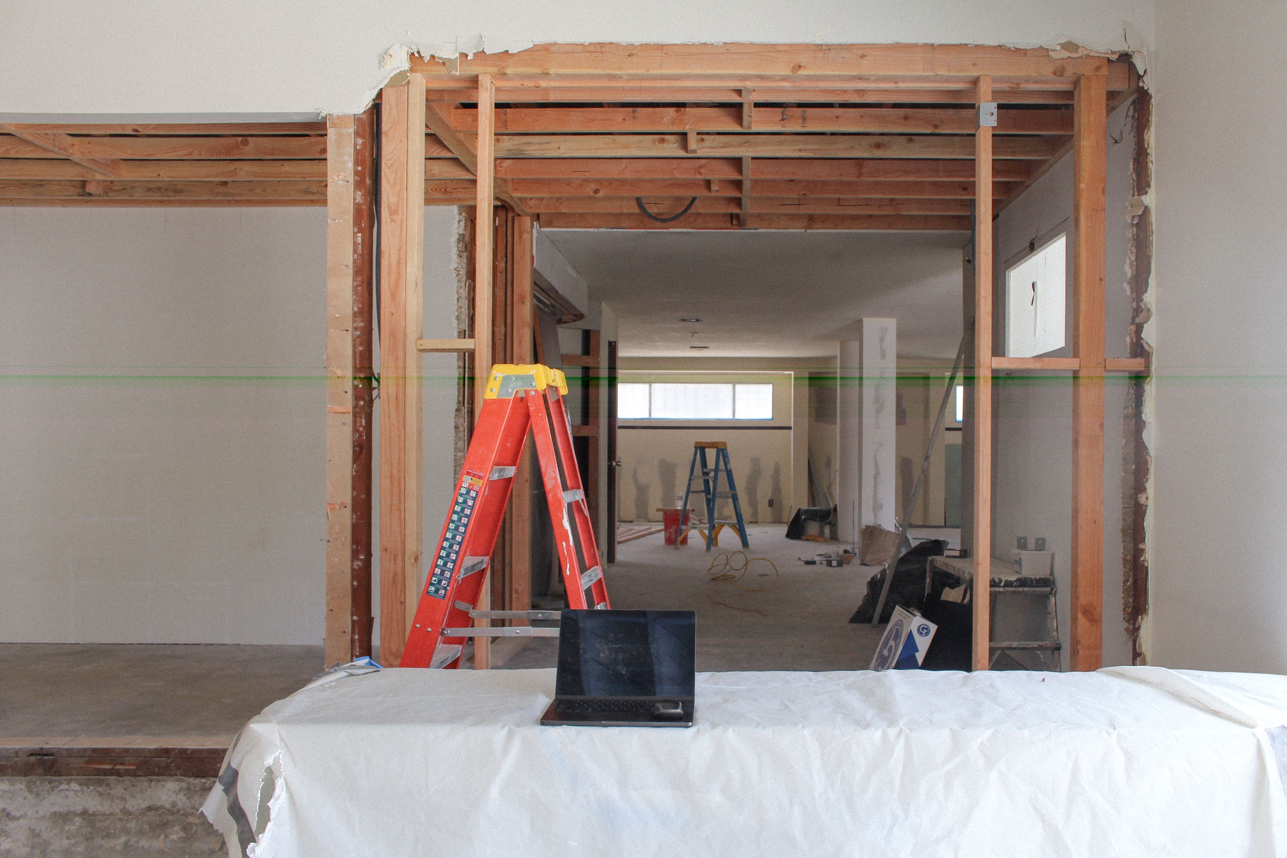 a construction site with a man walking up stairs, WOE, Width Over Ears