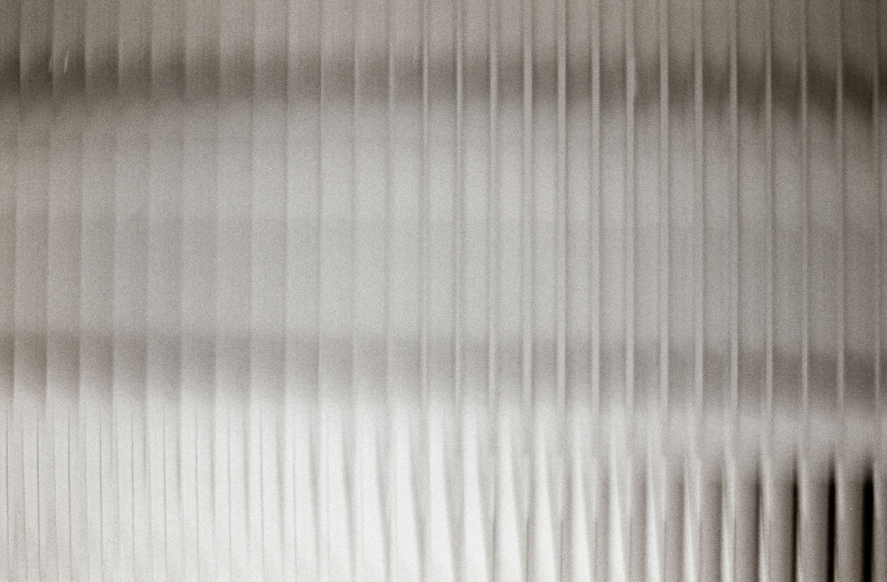 a black and white close up image of fluted glass