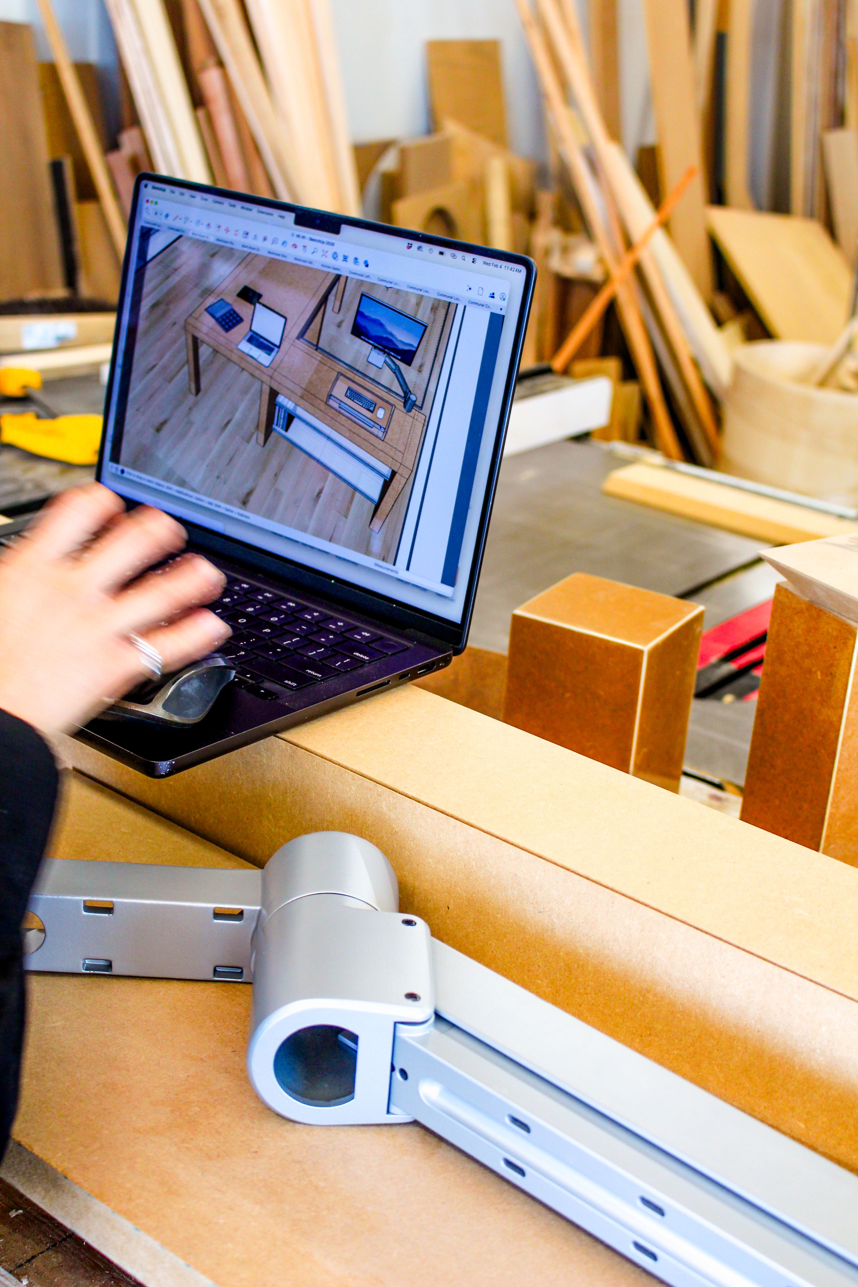 a workshop with a laptop on top of mdf, WOE, Width Over Ears