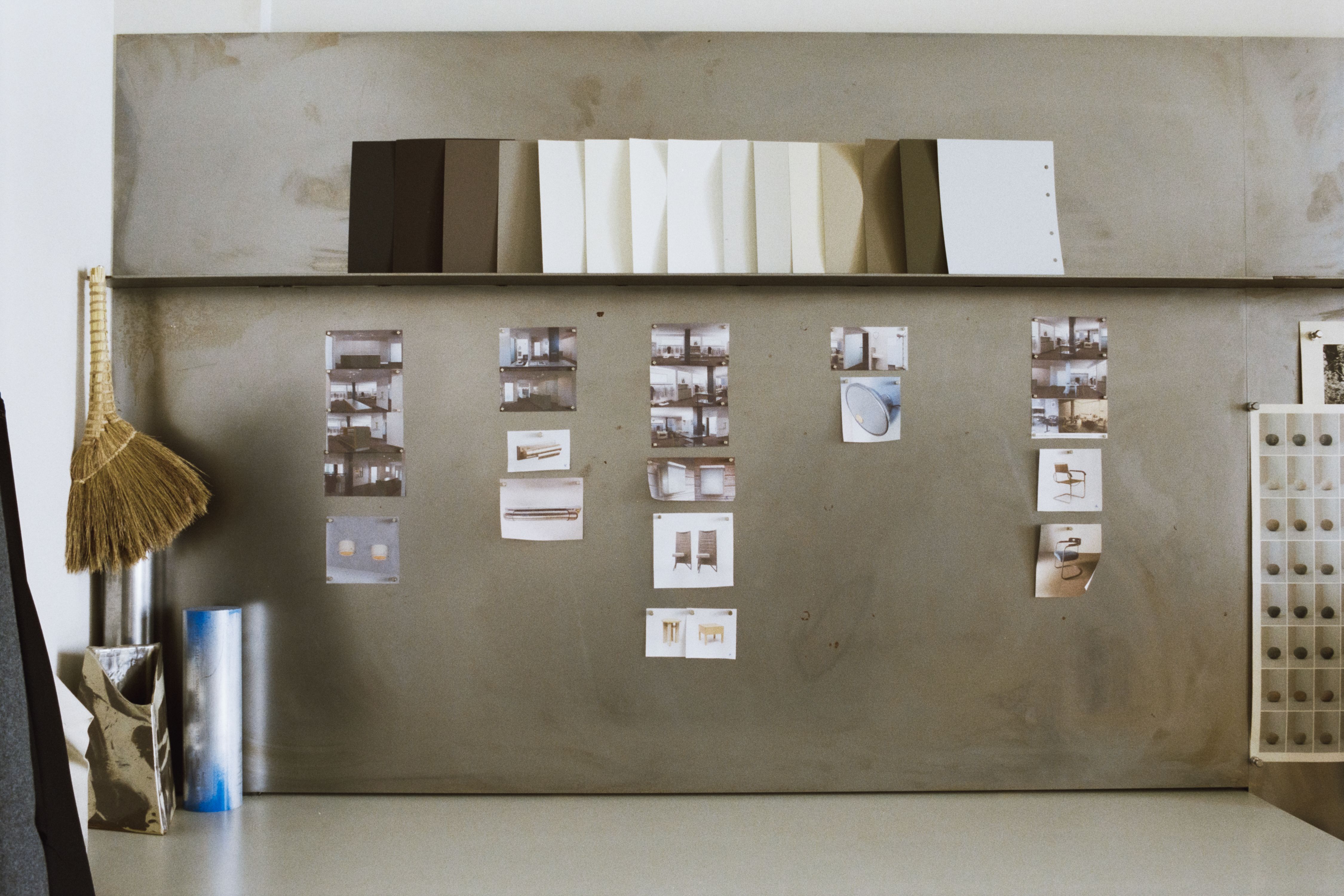 a wall of steel with various images and materials displayed, WOE, Width Over Ears