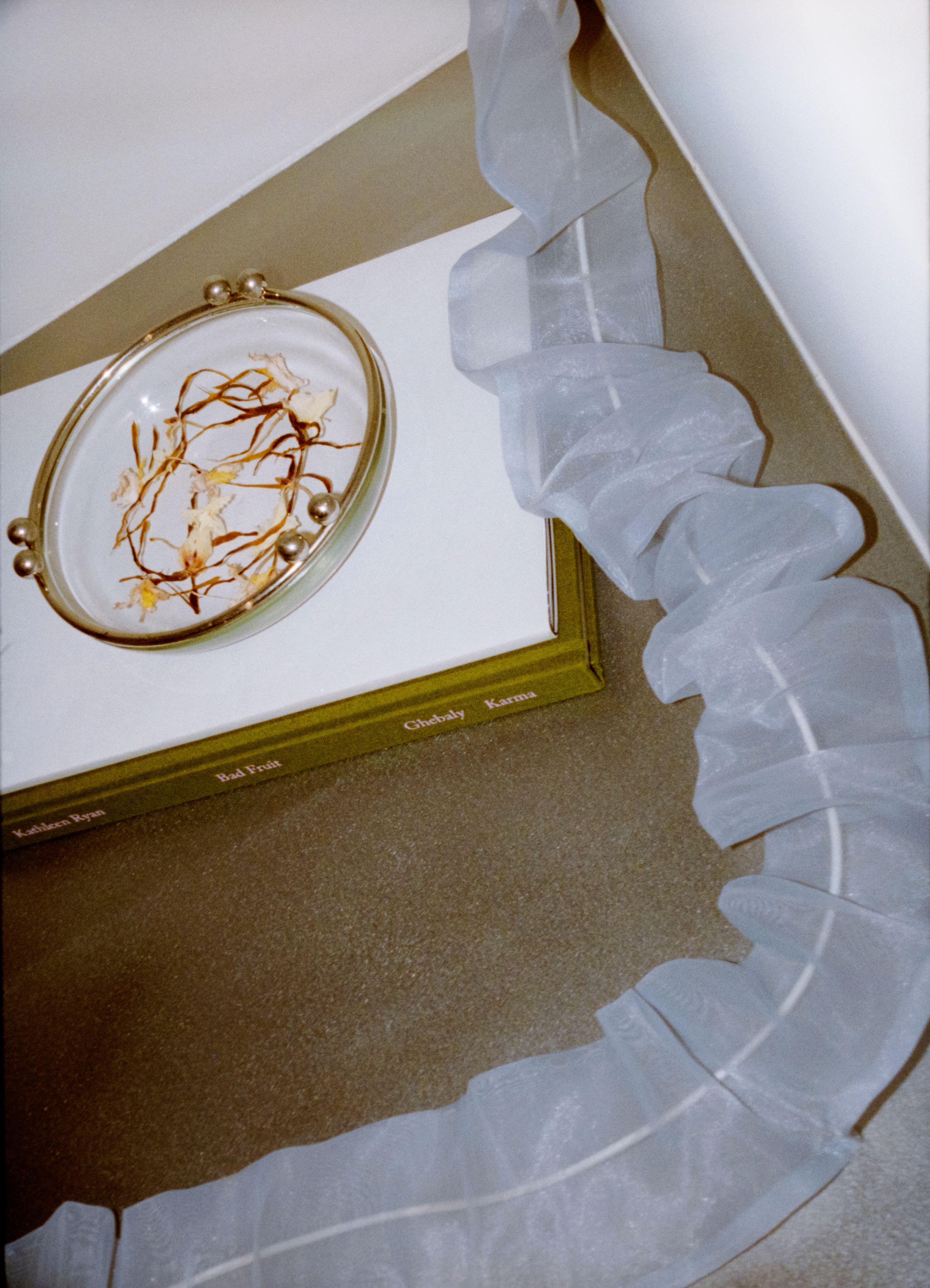 ruffled blue organza chord cover with a glass bowl with orchid leaves inside