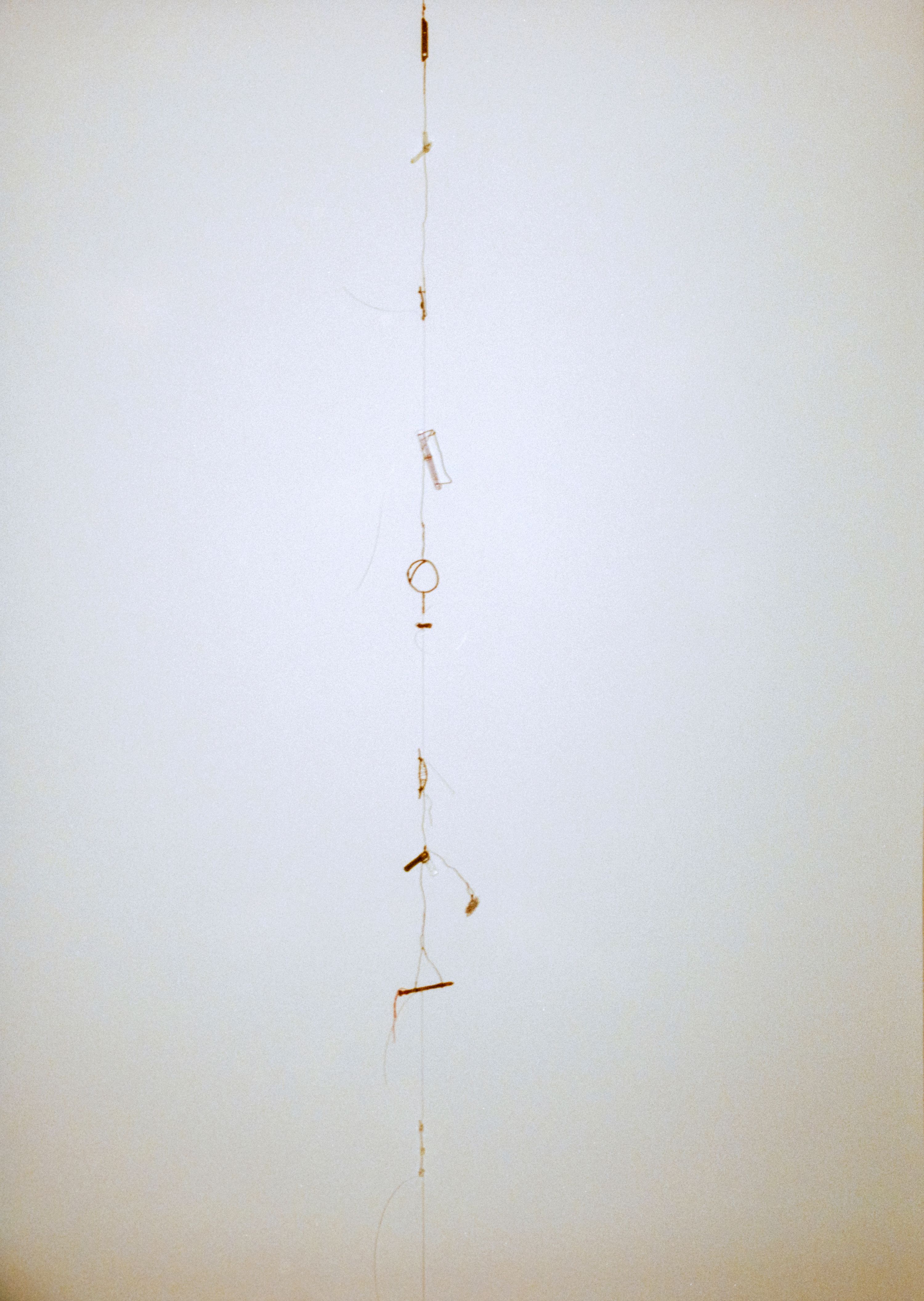 a white wall with sculpture against it
