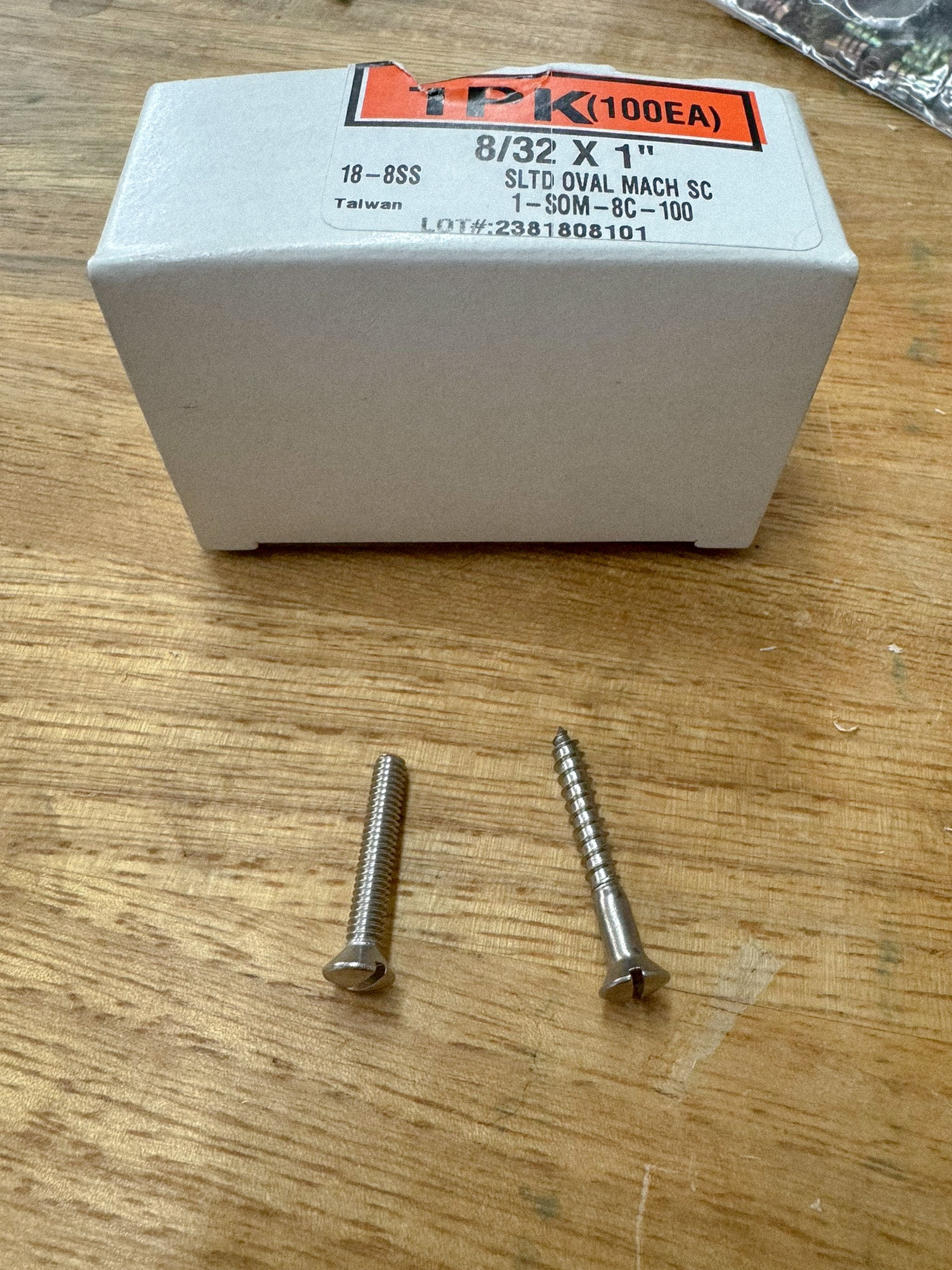 2 screws on a wooden table with a box, WOE, Width Over Ears