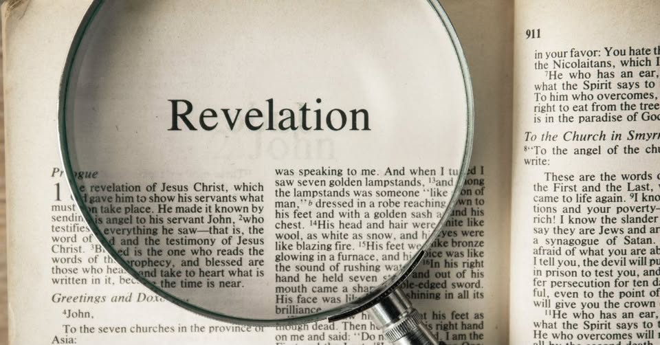 A Bible opened to the book of Revelation, under a magnifying glass