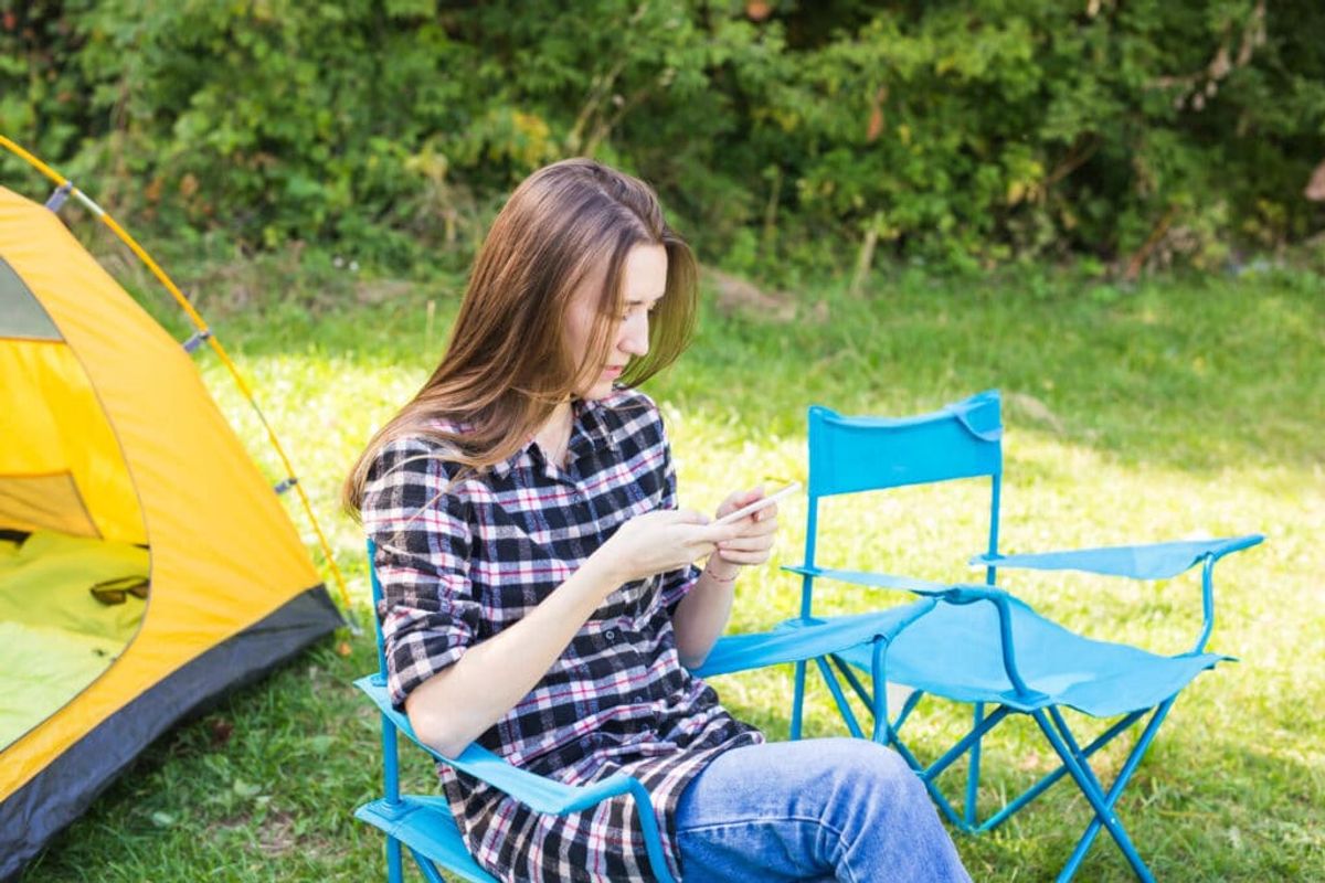 a woman reading a review of a camper 