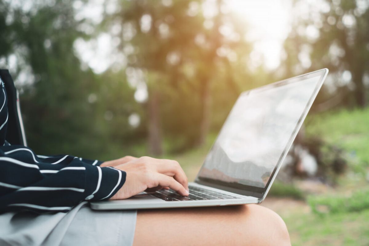 a woman using her laptop to see the list her campground in a marketplace