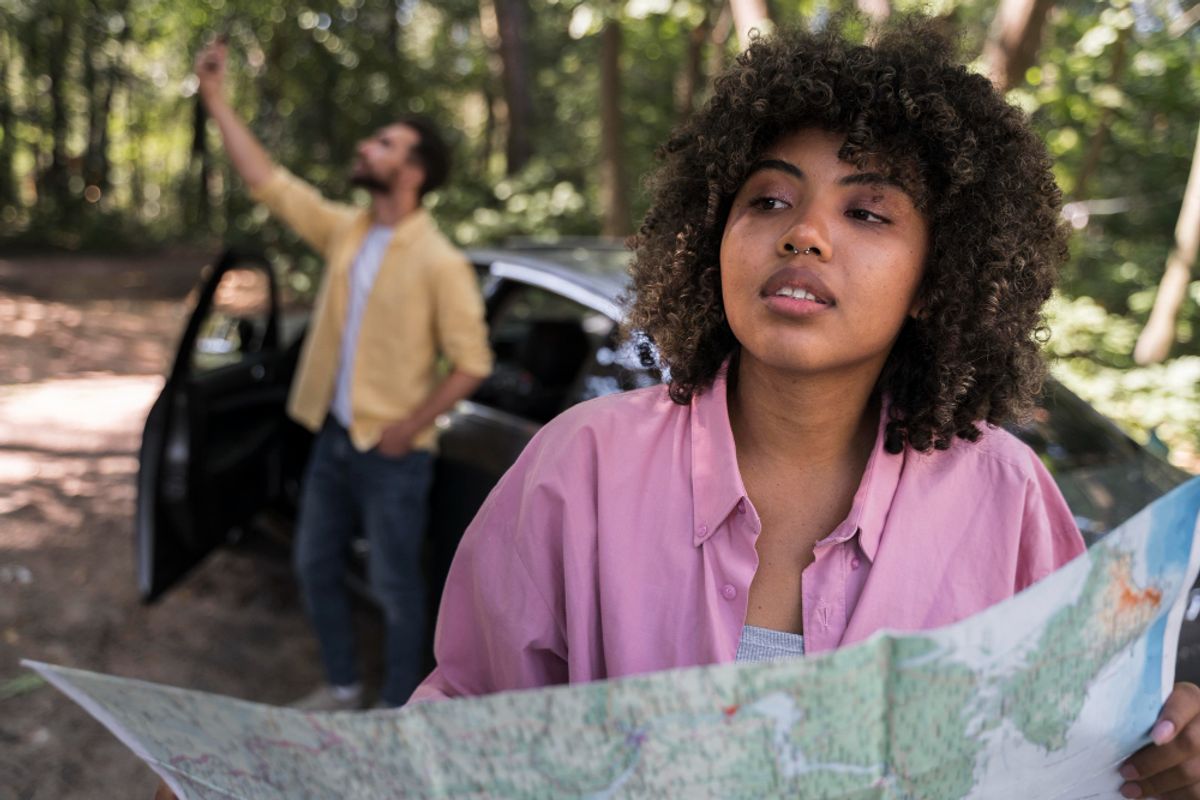 two people checing the map to find their next campground