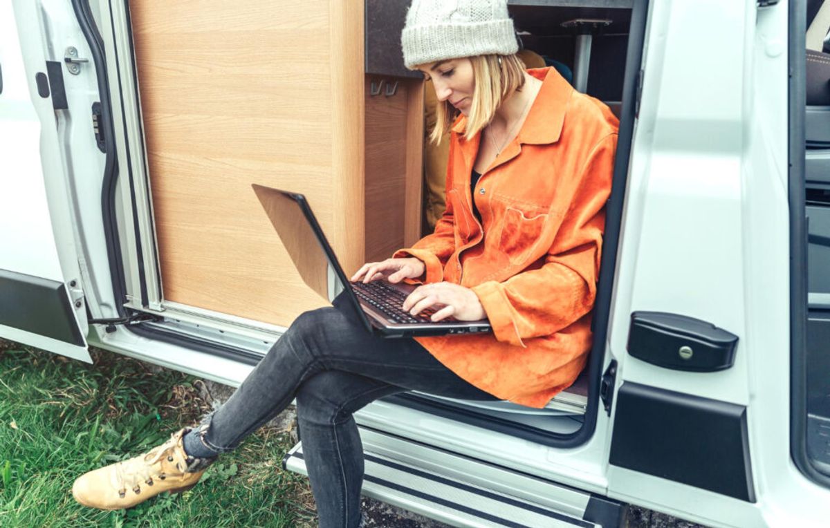 woman ysung laptop inside her rv park