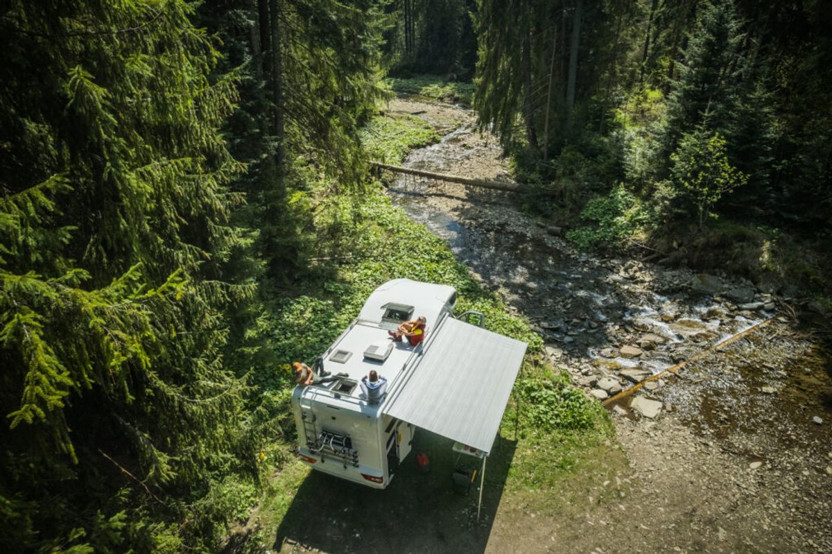 a single camper van in the forest 