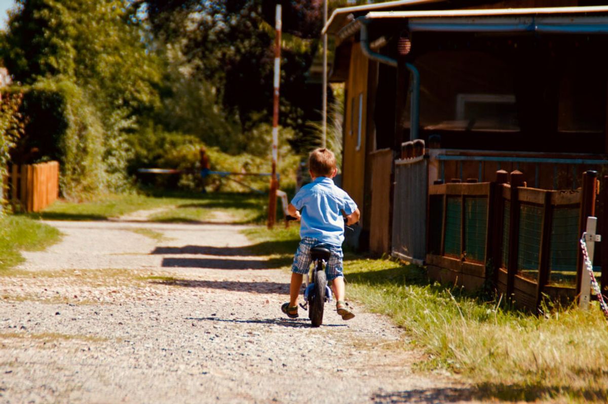 kid in a bike in a rv park playground 