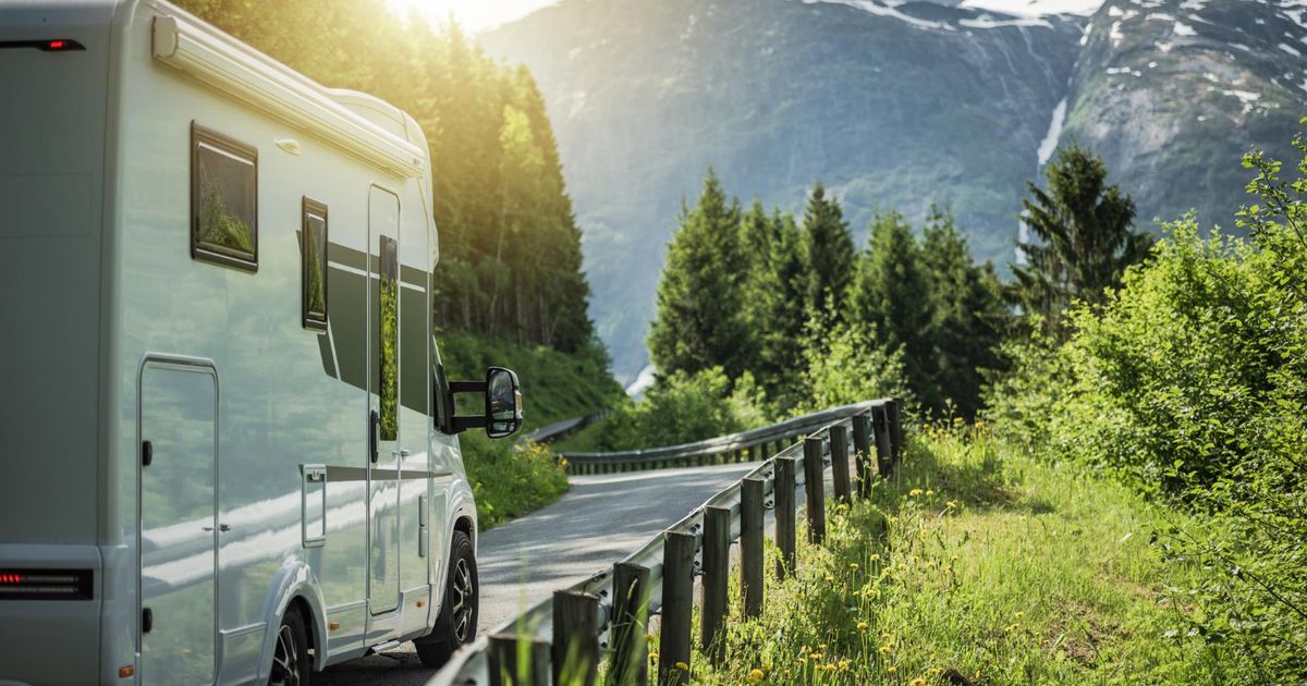 a camper van driving on the road to their next RV park reservation