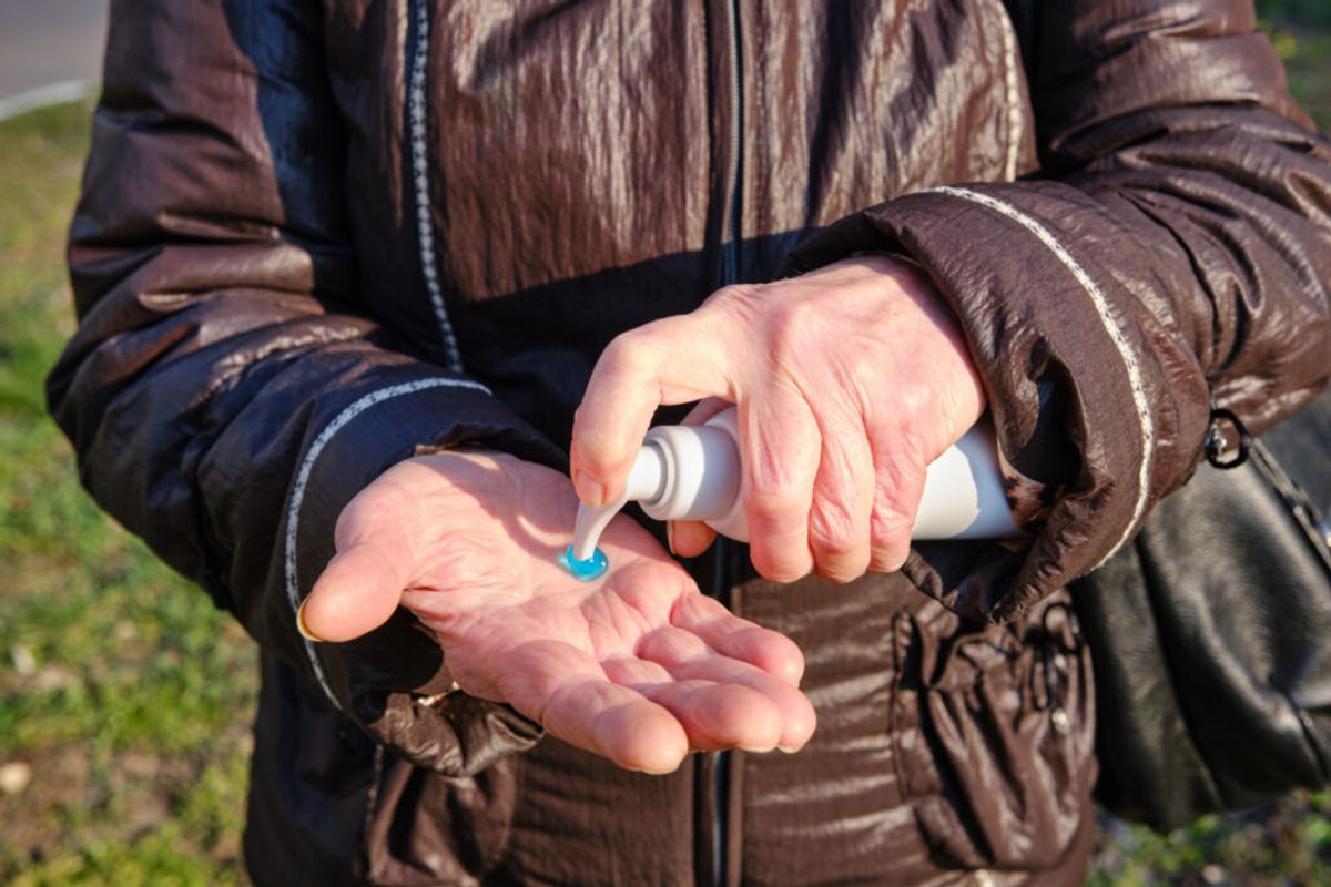 someone putting insect repelent gel in their hands 