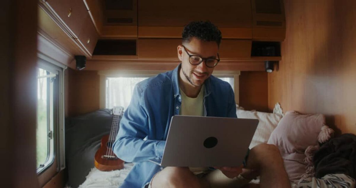 a man using a laptop to optimize campground listings 