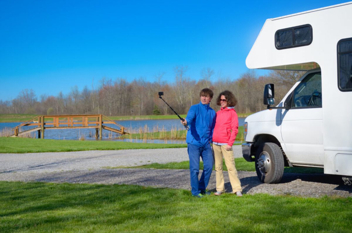 couple taking photos in a campground they found thanks to their RV park online reputation tips