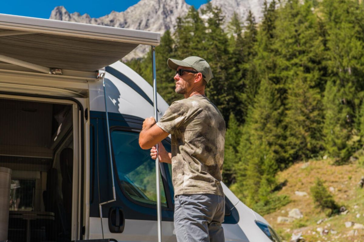 a customer of a RV park expanding his camper van in his camping spot thanks to campground registration software 