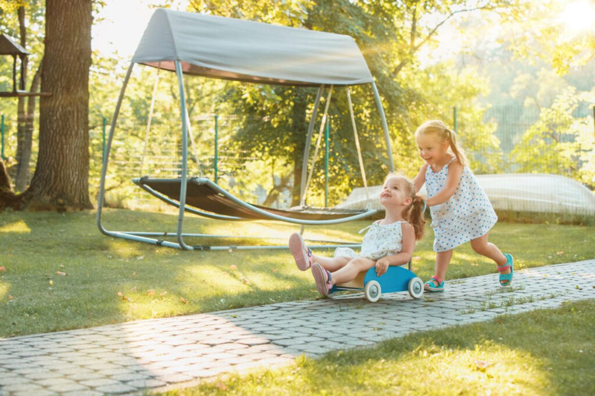 two girls playing in a RV park playground 