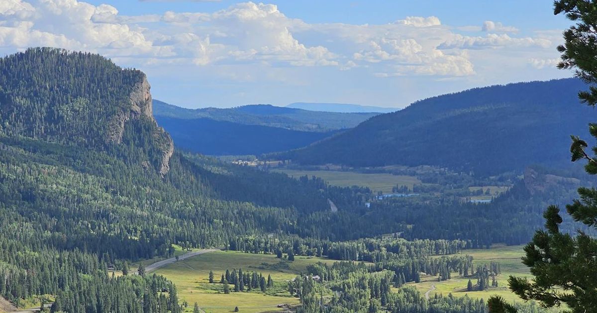 A blue sky with mountains and a river nearby