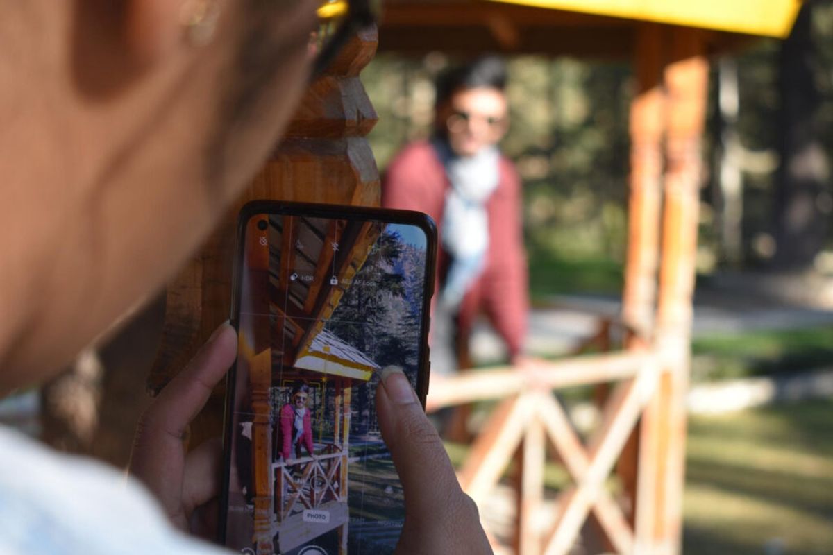 person taking pictures to improve their presence thanks to RV park online reputation tips