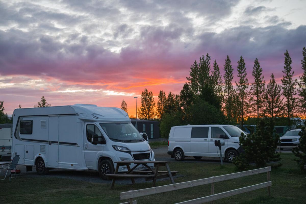 a group of campers in the sunset 