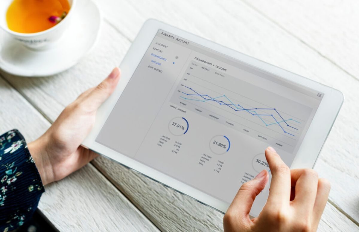 a person holding a tablet checking his reports and analytics using campground registration software 