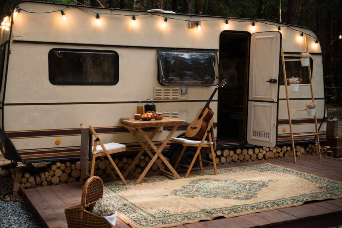 A campground in the forest with a guitar, fruits and lights