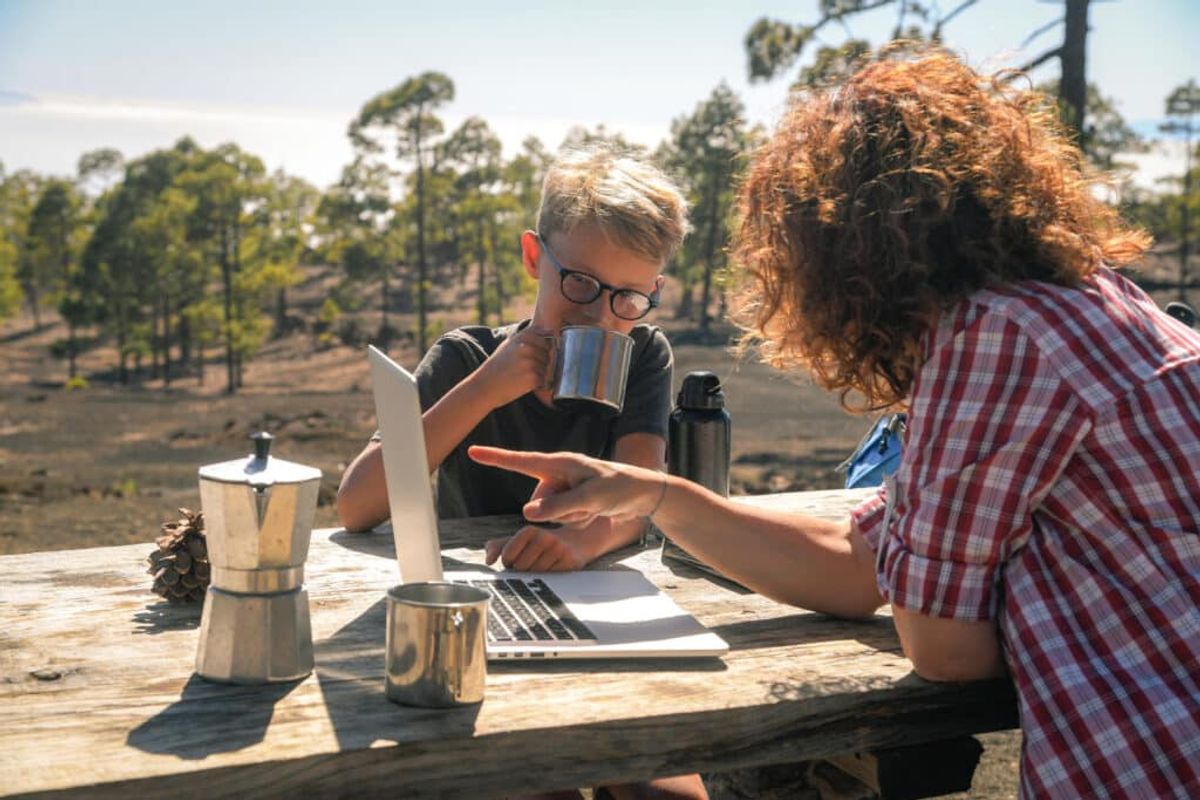 a woman using laptop to check on the reviews of her campground listings 