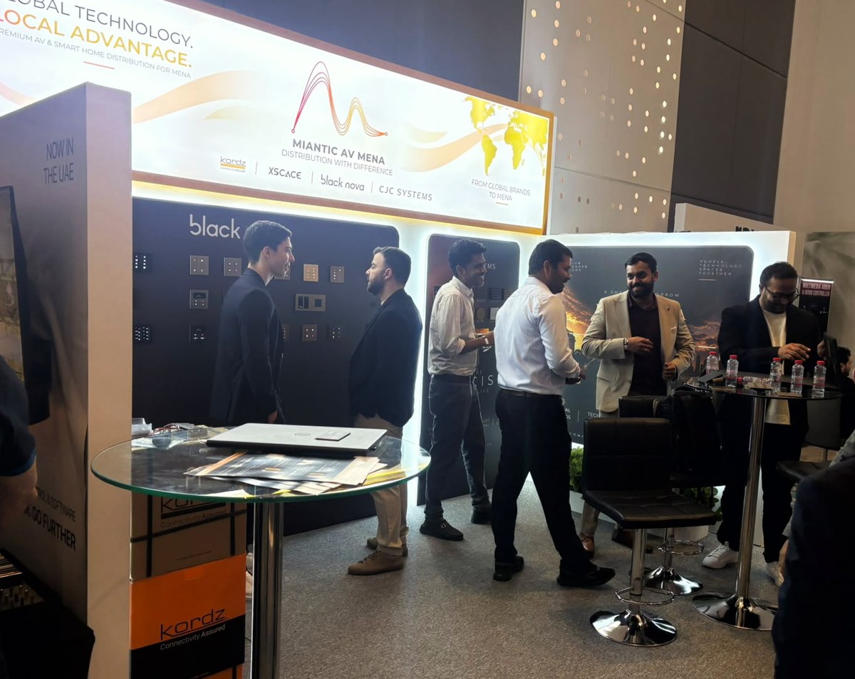 Visitors in conversation at the XSCACE and Miantic AV MENA stand at the High End and Smart Home Show 2026