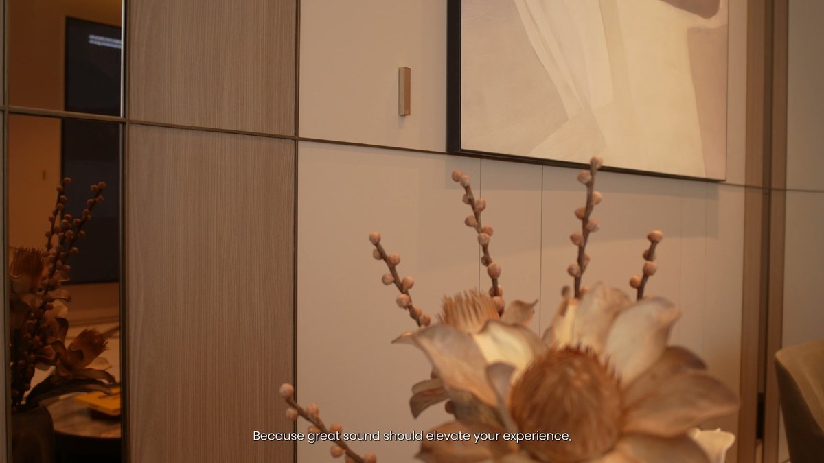 A white XSCACE Bonsai on a wall panel above a vase of dried blossom in the lounge