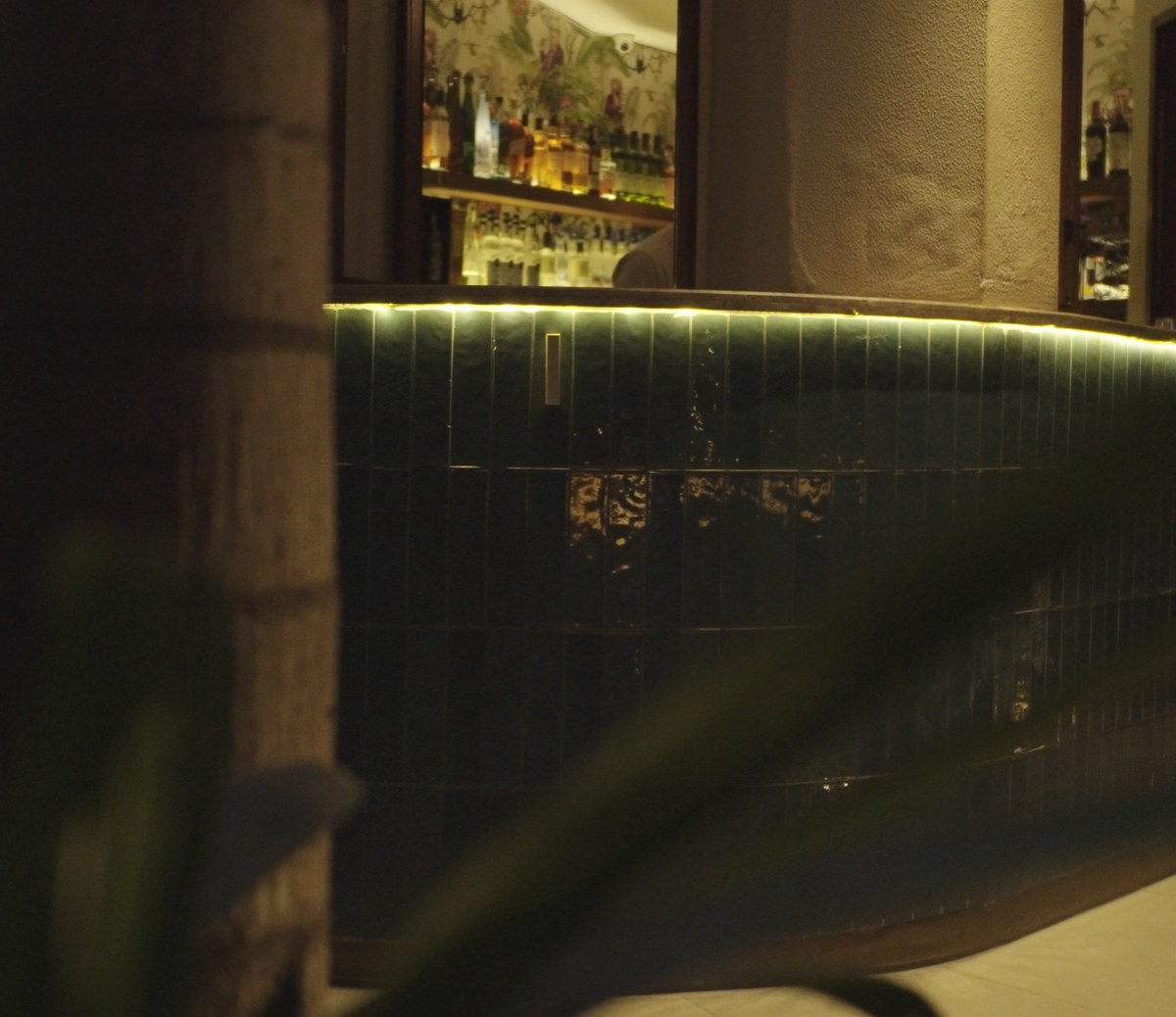 XSCACE Bonsai speaker mounted on emerald glazed tile at a restaurant bar counter