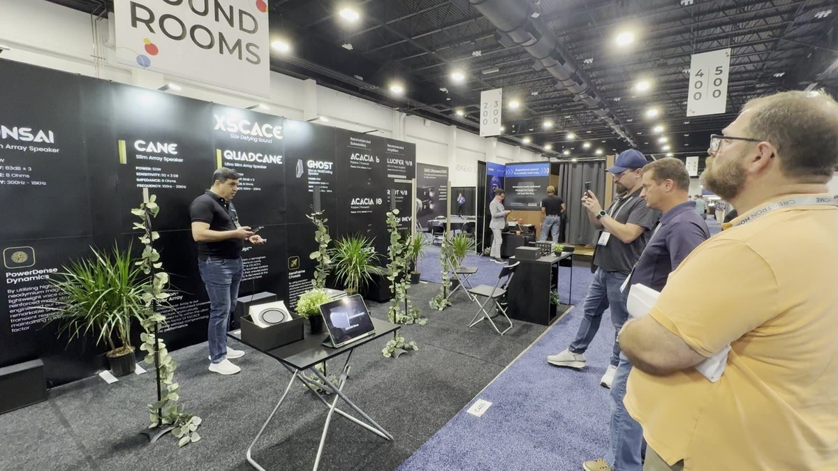The XSCACE aisle frontage at CEDIA Expo 2024, showing the Bonsai, Cane, QuadCane, Ghost, Acacia 6 and Acacia 10 panels with their specifications, and a demonstration table in front