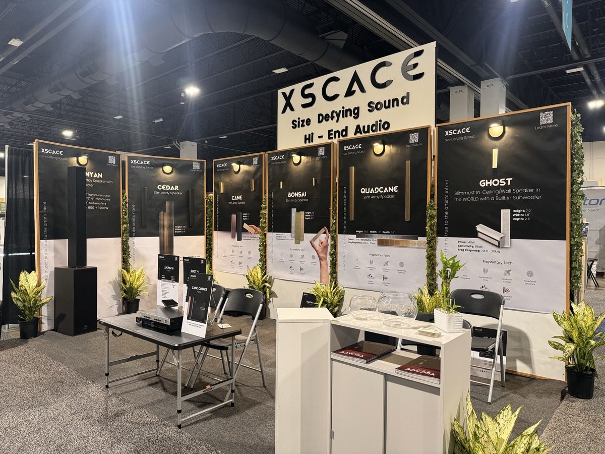 The XSCACE product display wall at CEDIA Expo 2025, with individual panels for Banyan, Cedar, Cane, Bonsai, QuadCane and Ghost, each showing the speaker alongside its published specifications
